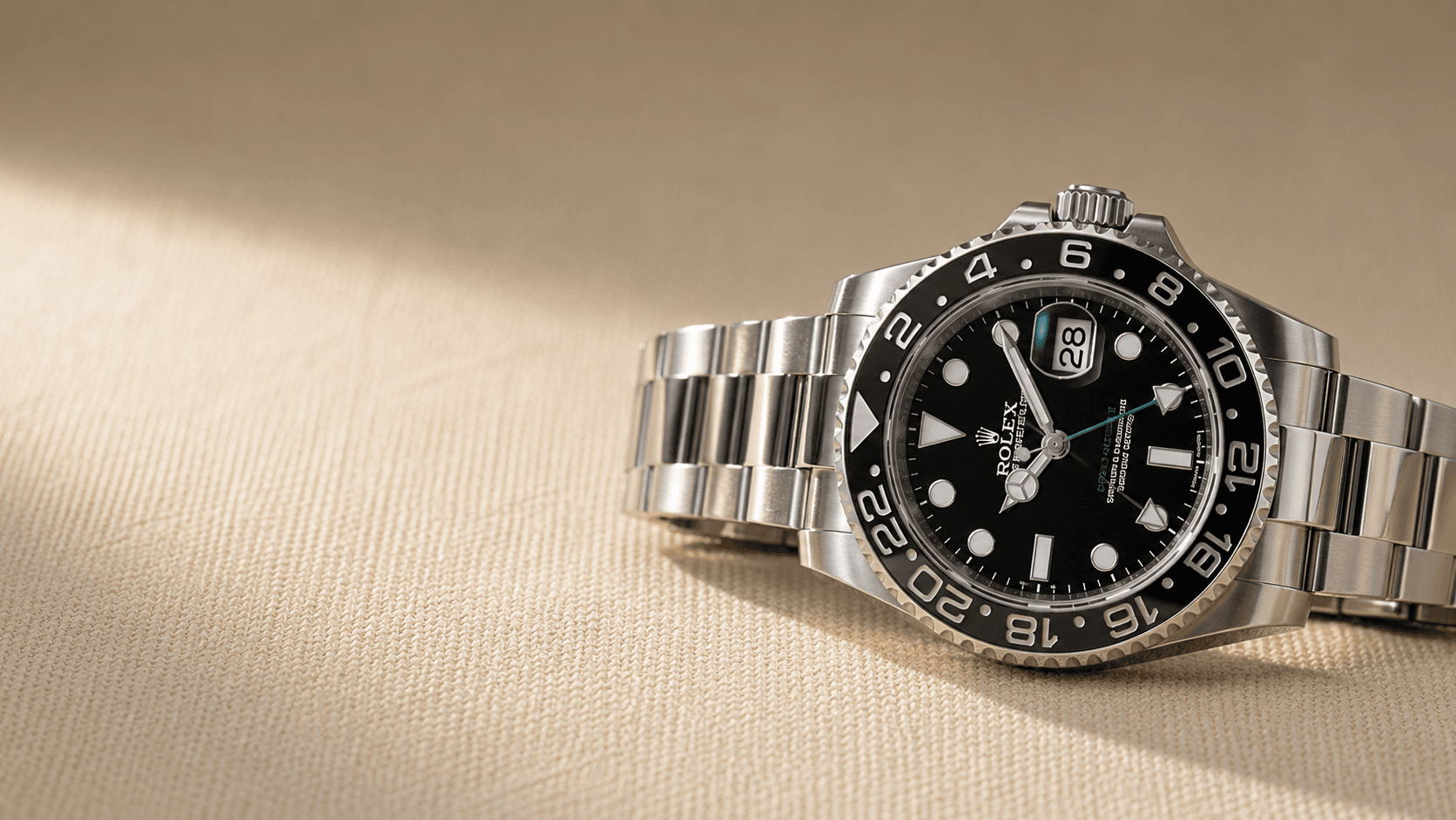 Luxury Rolex GMT-Master II watch on cream linen