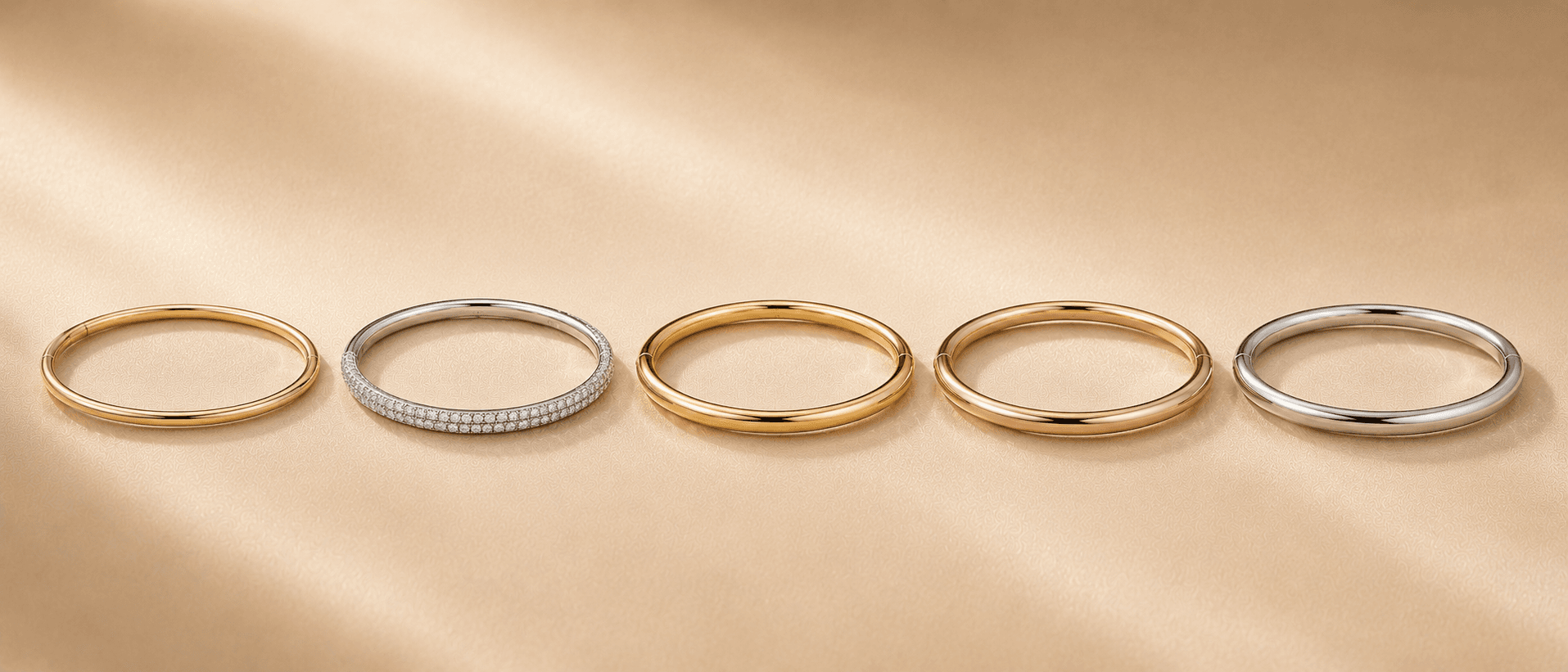 Stack of gold and diamond bangles at ATL Luxury Jewelers Atlanta