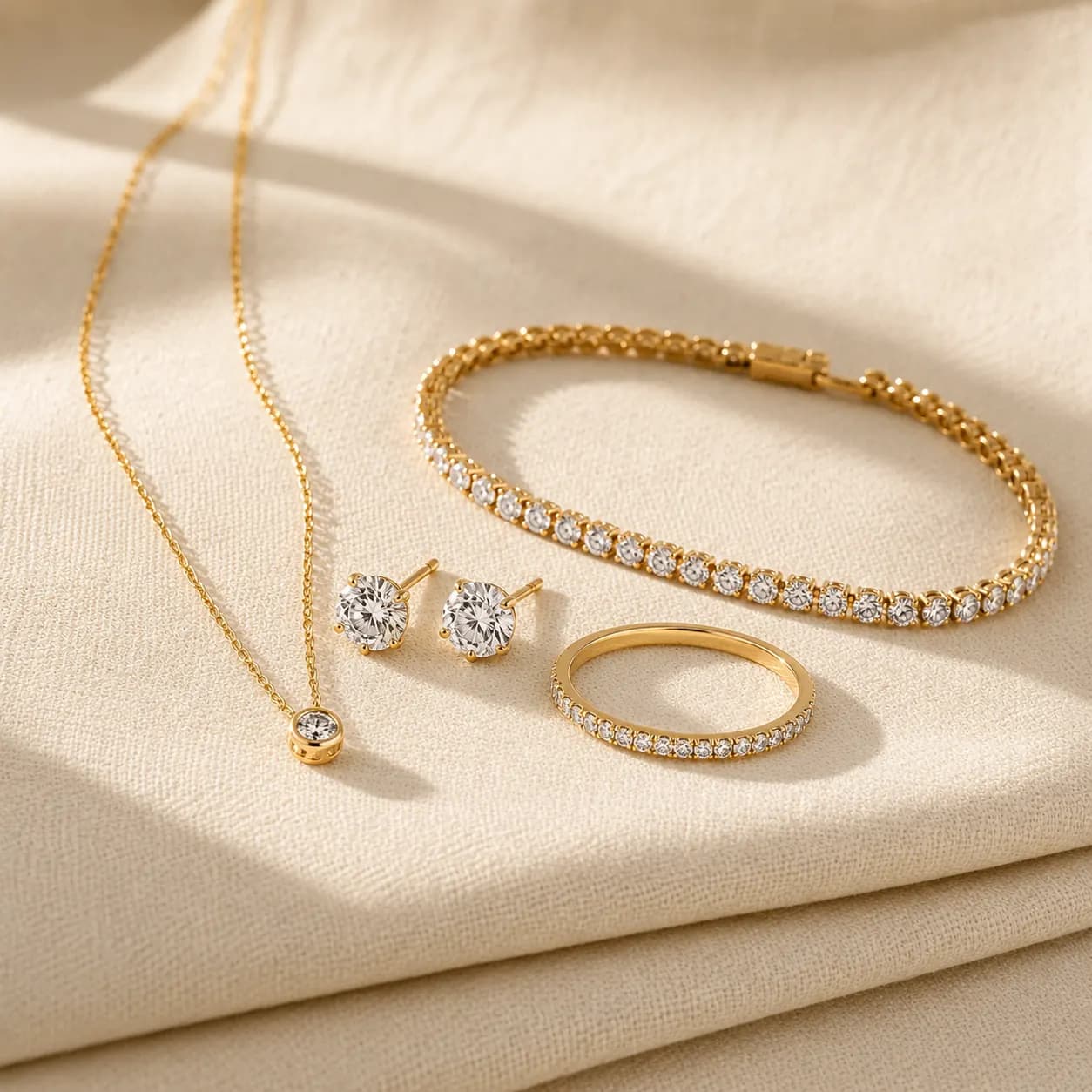 Women's fine jewelry collection — gold necklaces, diamond stud earrings, tennis bracelets, and signature rings at ATL Luxury Jewelry Atlanta