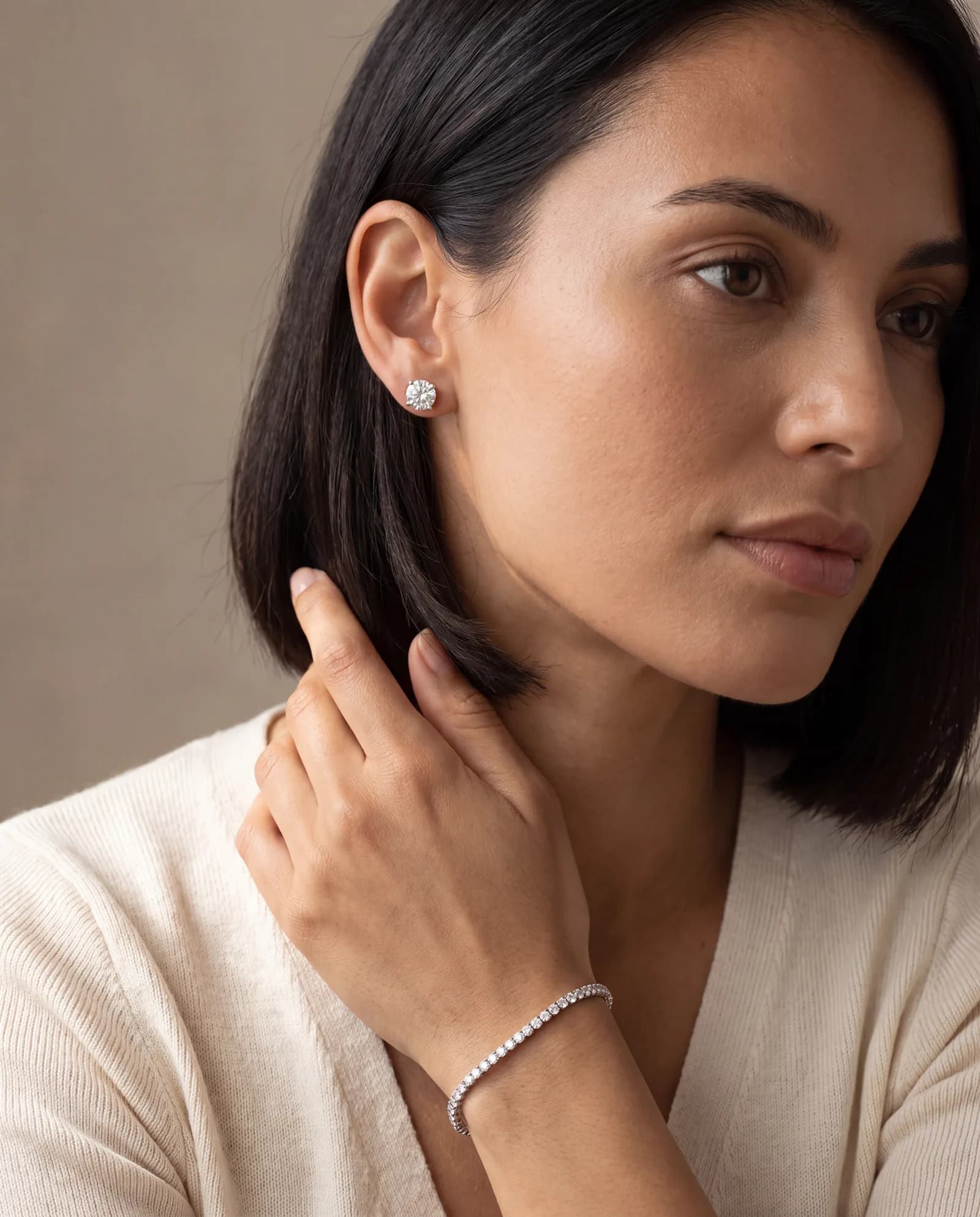 Woman wearing diamond stud earrings and a diamond line bracelet, ATL Luxury Jewelry, Atlanta