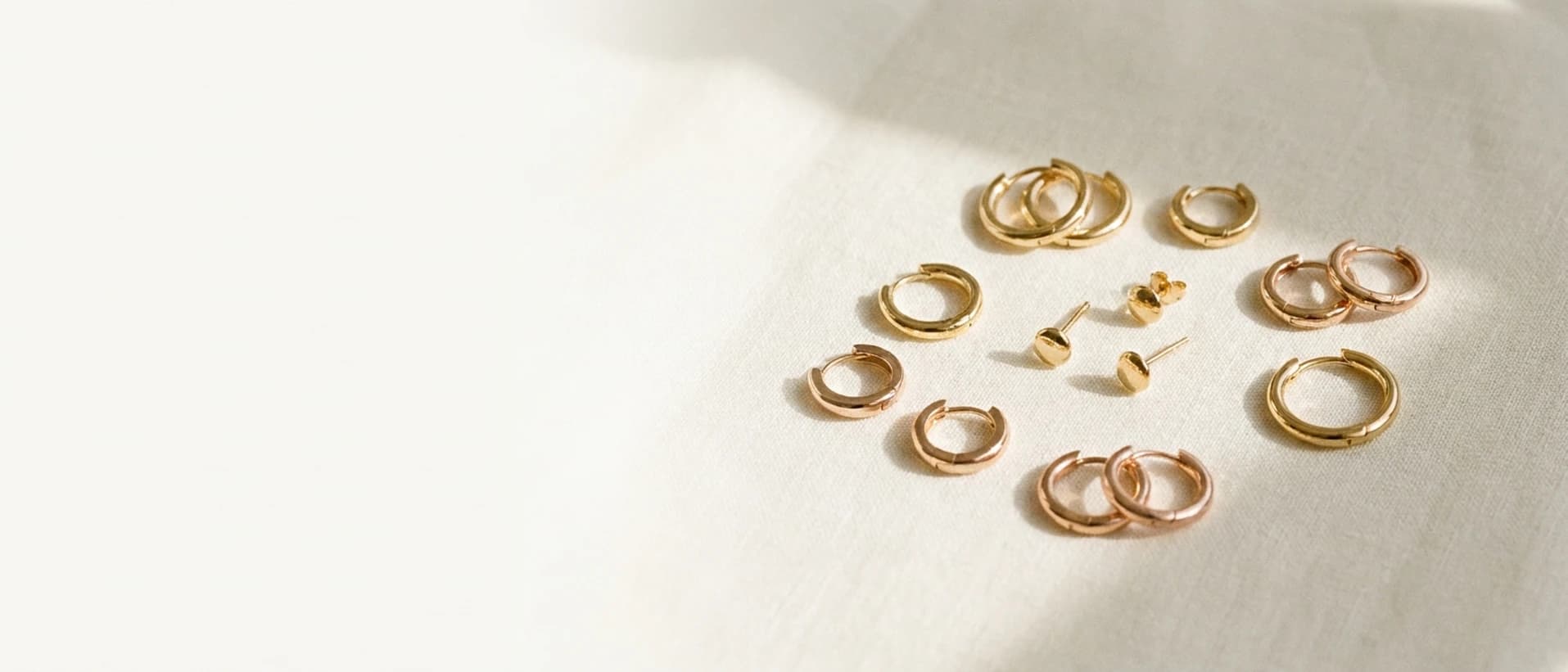 Solid 14K gold earrings on cream linen at ATL Luxury Jewelry Atlanta