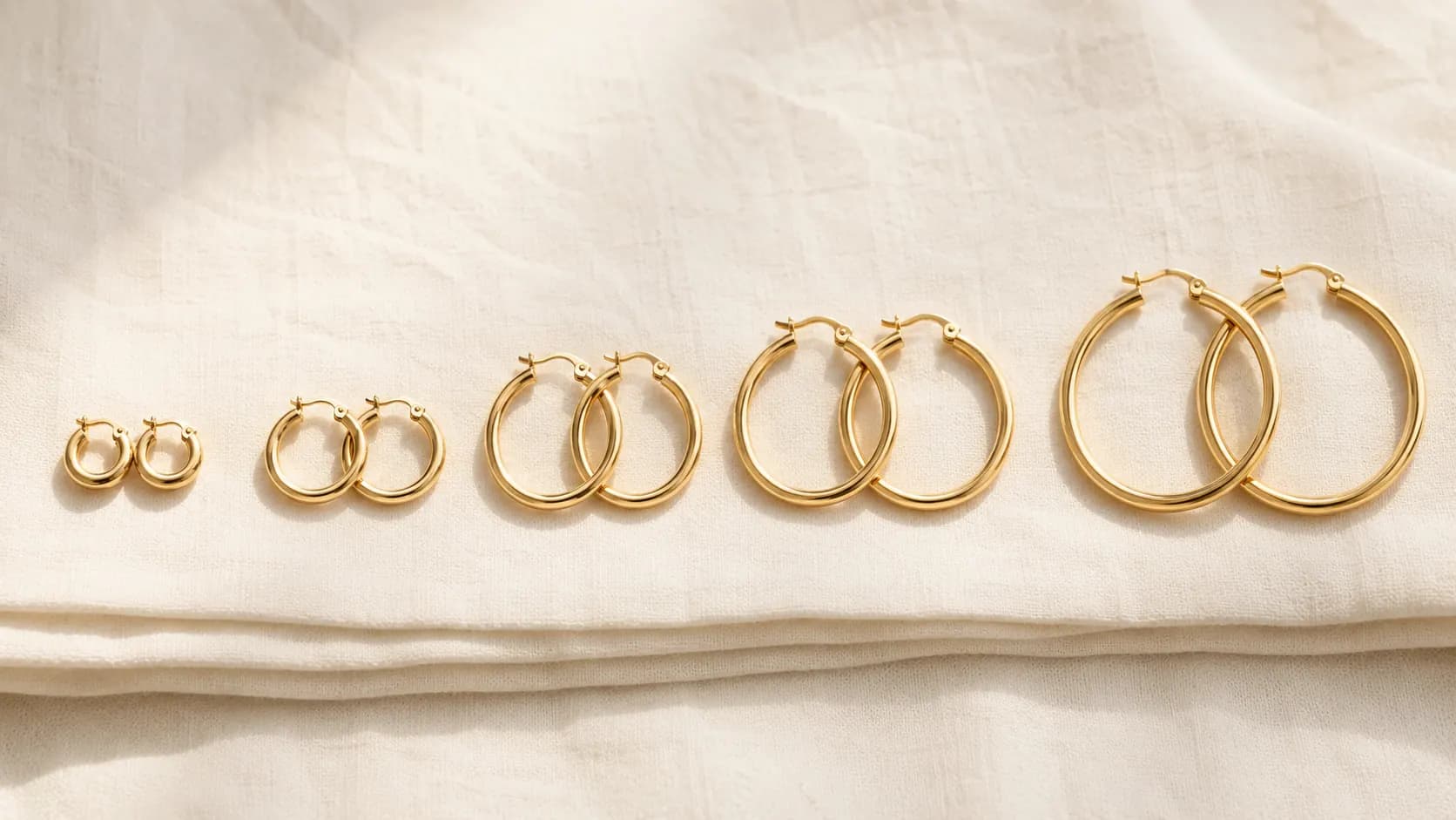 Gold hoop earrings in 10mm, 20mm, 30mm, 40mm, and 50mm diameter progression at ATL Luxury Jewelry Atlanta