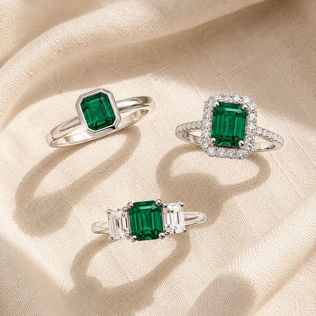 Emerald bezel halo three stone protective settings at ATL Luxury Jewelry Atlanta