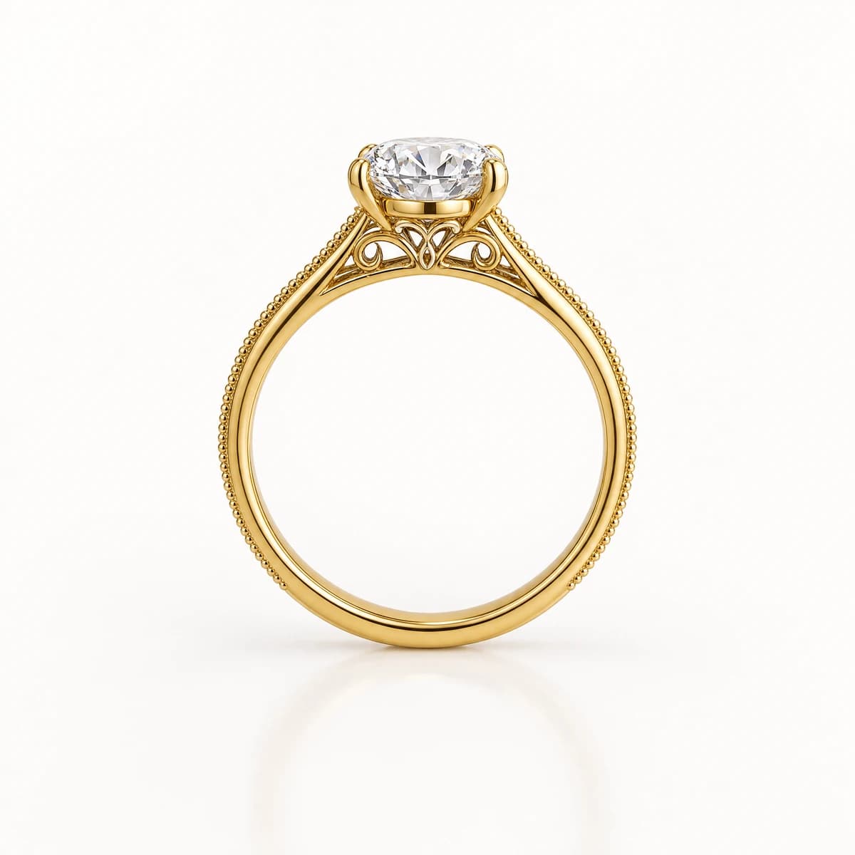 A yellow gold solitaire ring standing upright on a pale background, milgrain beading along both edges of the band and an openwork gallery beneath the centre diamond