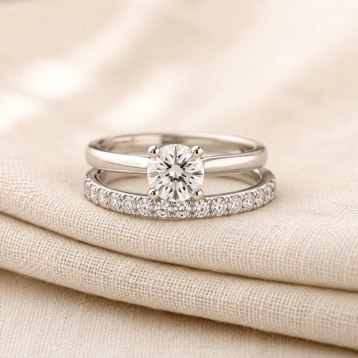 Diamond eternity anniversary band stacked with engagement ring on cream linen at ATL Luxury Jewelers Atlanta