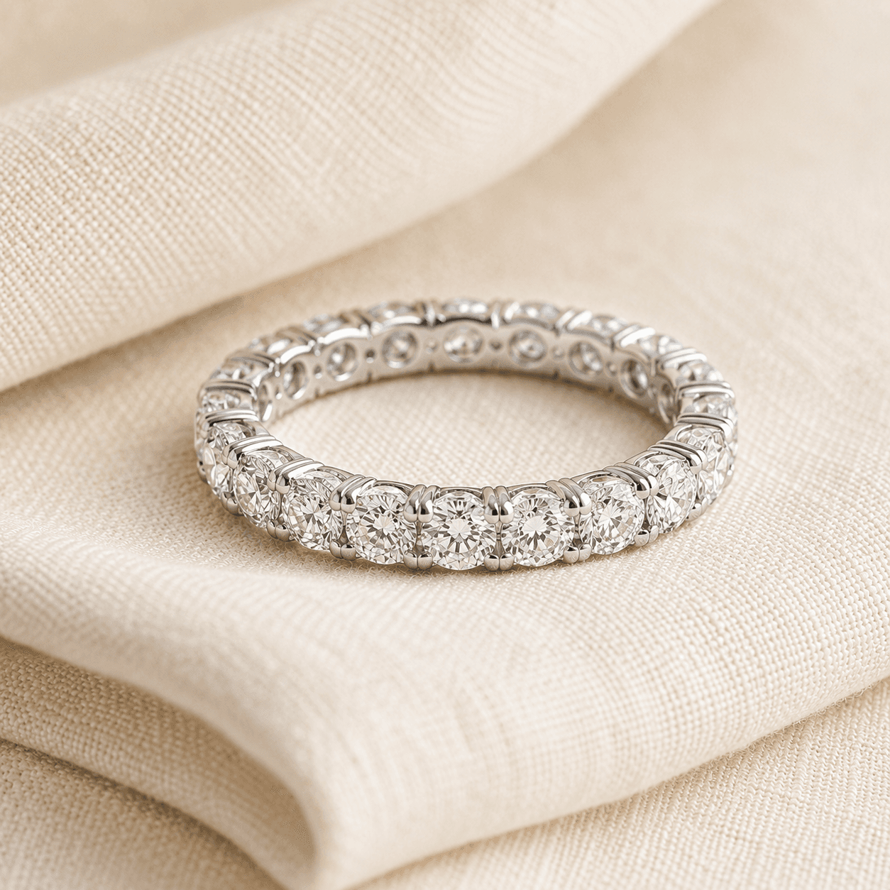 Diamond eternity wedding band in platinum on cream linen at ATL Luxury Jewelers Atlanta