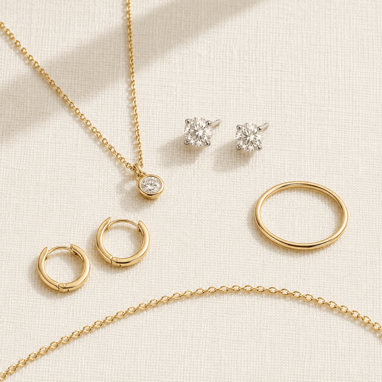 Daily-wear jewelry categories — delicate chain, diamond studs, simple pendant at ATL Luxury Jewelers
