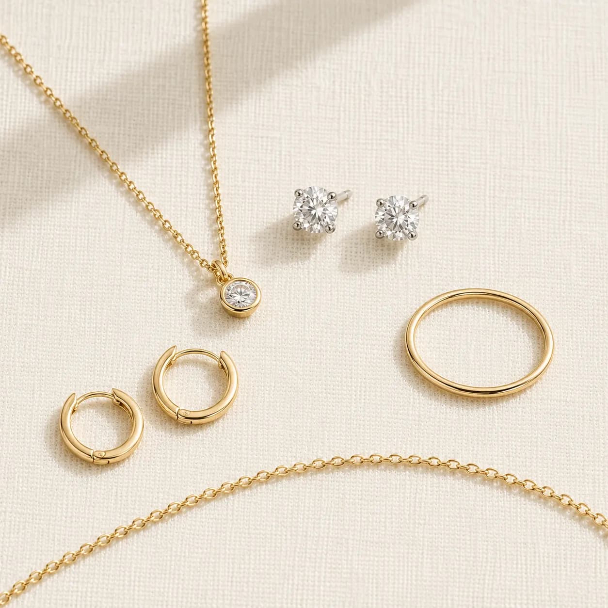 Daily-wear jewelry categories — delicate chain, diamond studs, simple pendant at ATL Luxury Jewelry