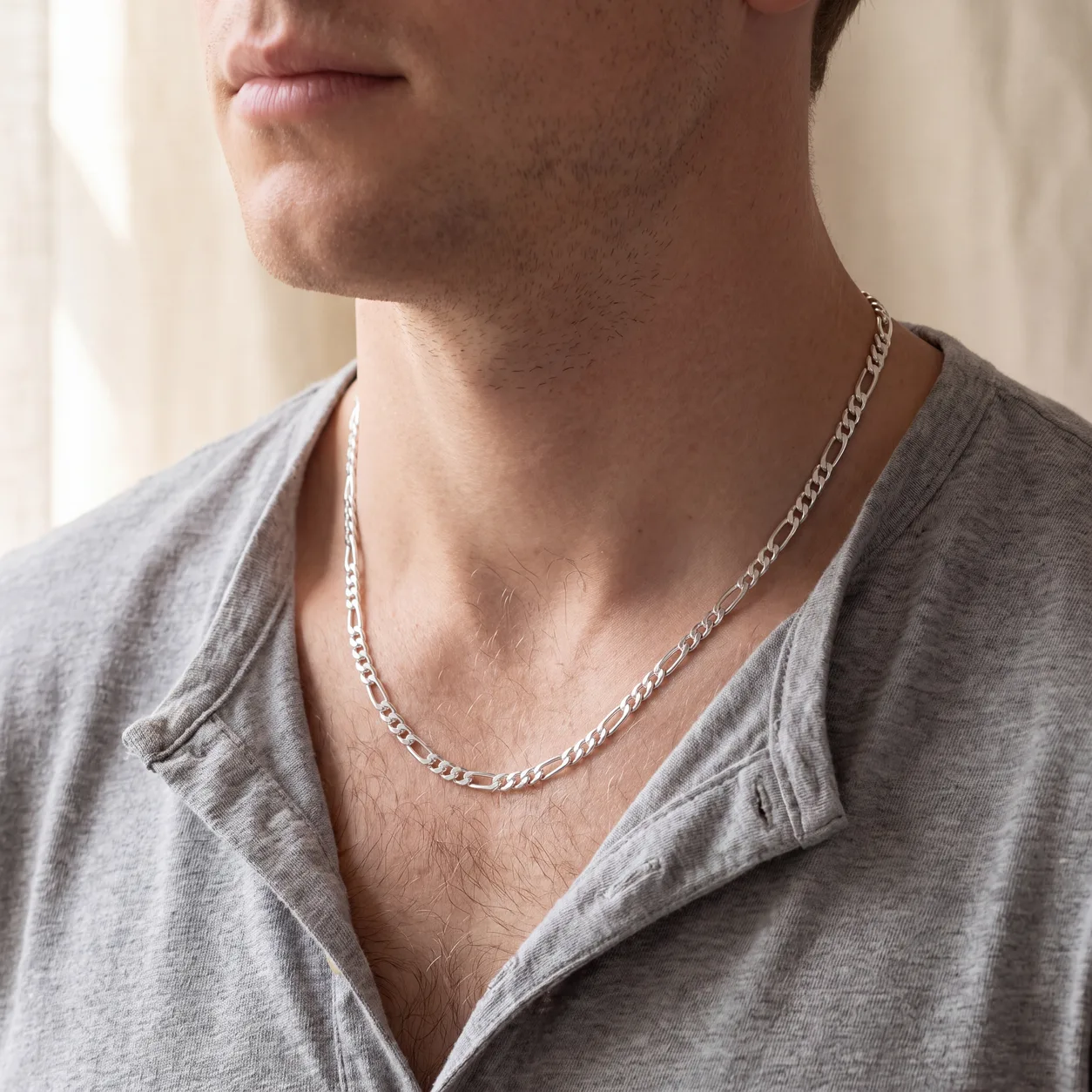 A gold curb chain necklace laid on linen