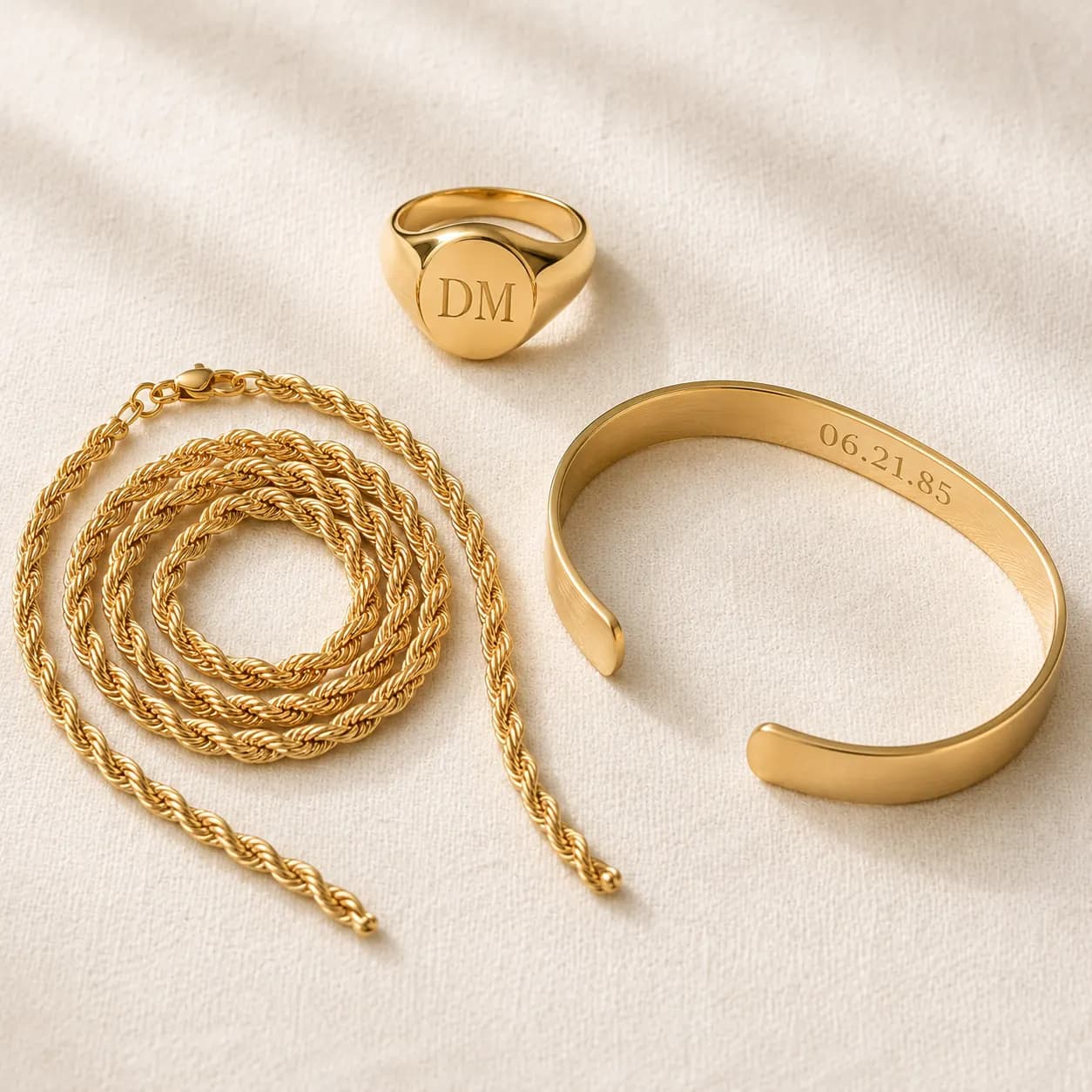 Men's signet ring, gold rope chain, and engraved cuff bracelet at ATL Luxury Jewelry Atlanta
