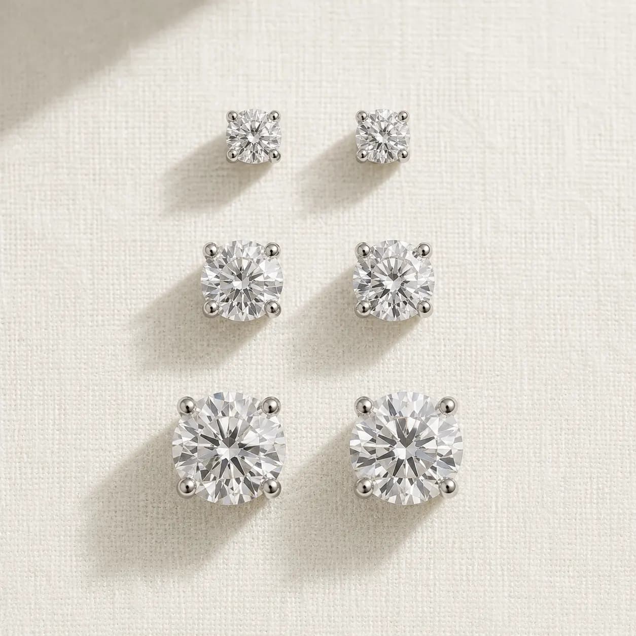 Diamond stud earrings in three carat sizes at ATL Luxury Jewelers