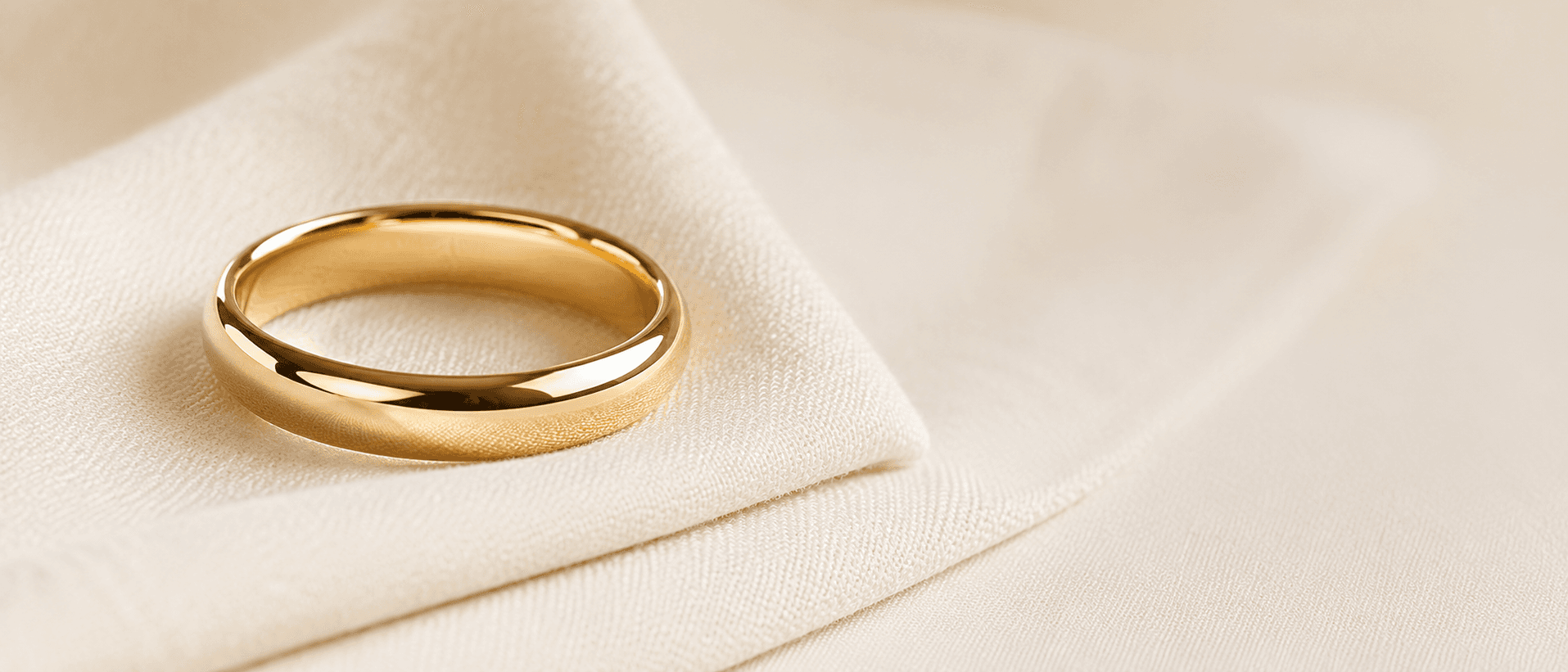 Yellow gold wedding band on cream linen, handcrafted at ATL Luxury Jewelers in Atlanta