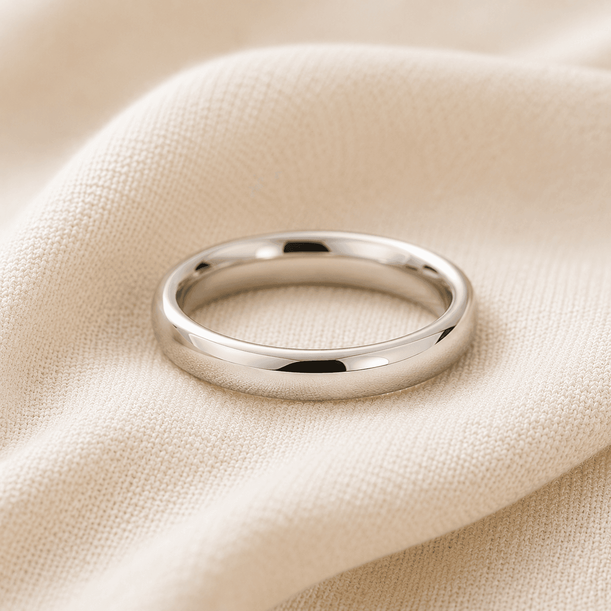 14K white gold wedding band on cream linen at ATL Luxury Jewelers Atlanta