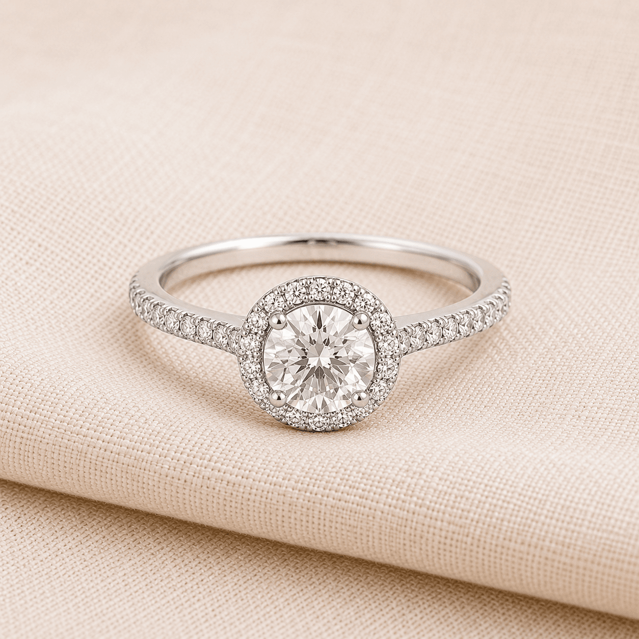 Halo engagement ring for women on cream linen at ATL Luxury Jewelers Atlanta