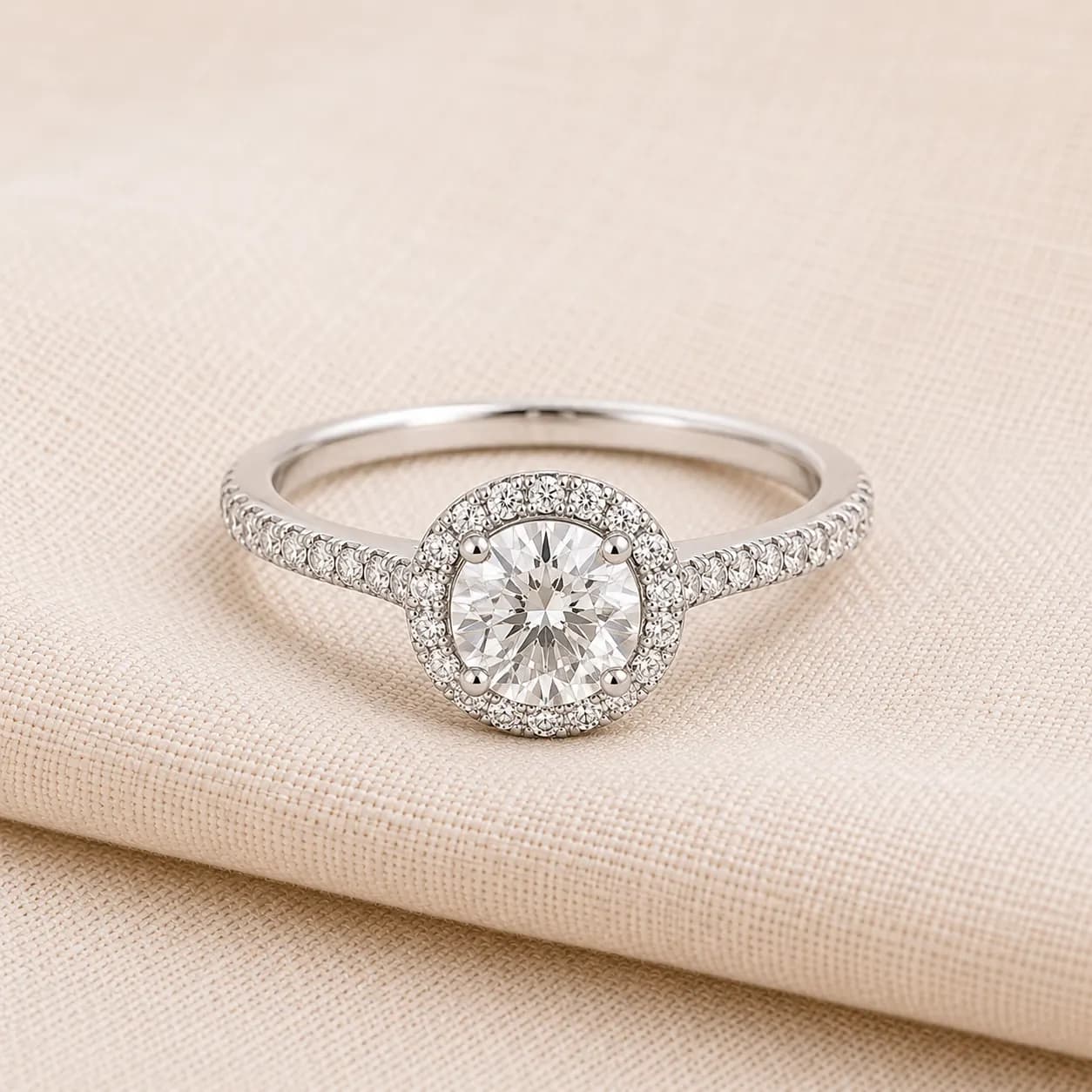 Halo engagement ring for women on cream linen at ATL Luxury Jewelry Atlanta