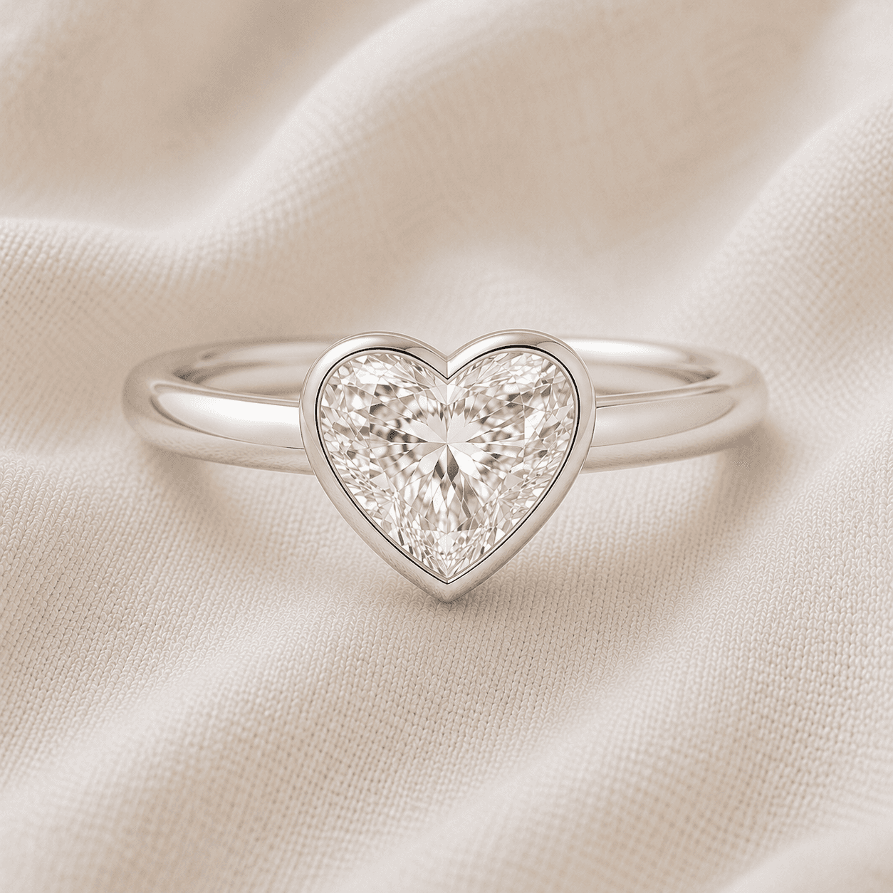 Bezel-set heart shaped engagement ring in white gold