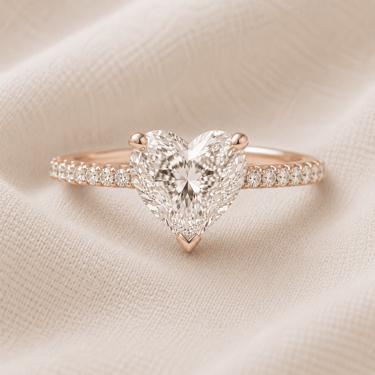 Heart shaped engagement ring with pavé diamond band in rose gold