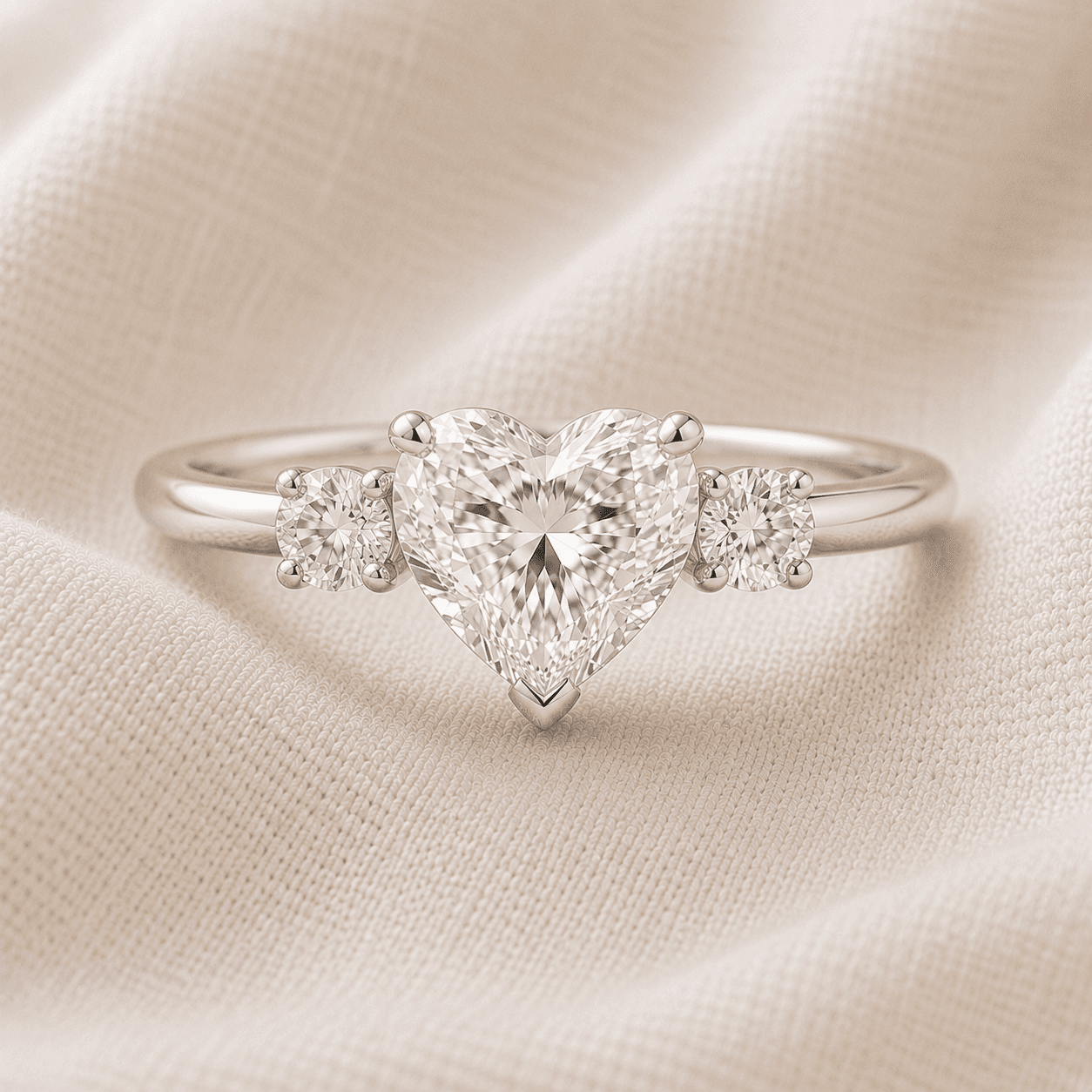 Heart shaped three-stone engagement ring with round side stones