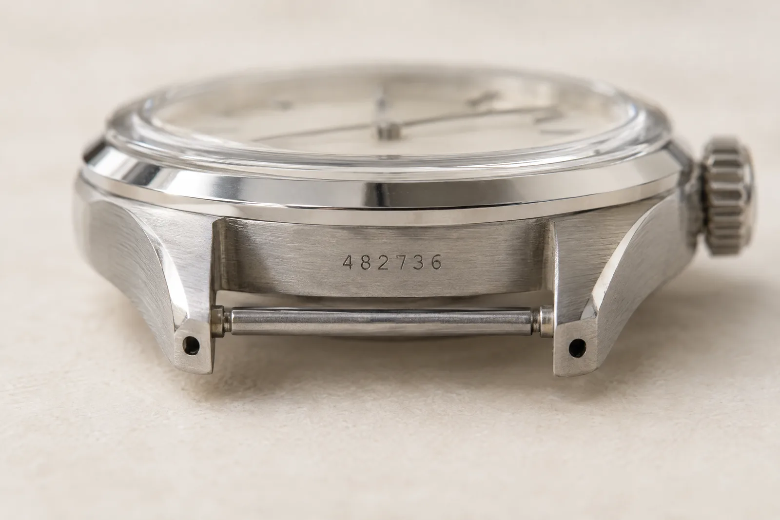 A close-up of a reference number engraved on the case of a luxury watch