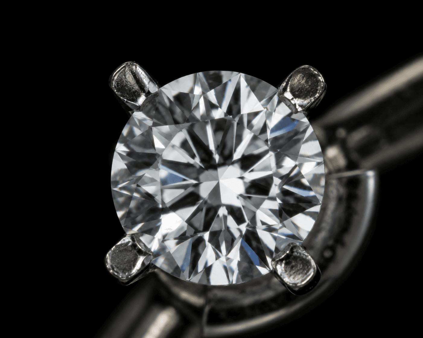 Macro detail of a round brilliant diamond prong-set in platinum at ATL Luxury Jewelers Atlanta