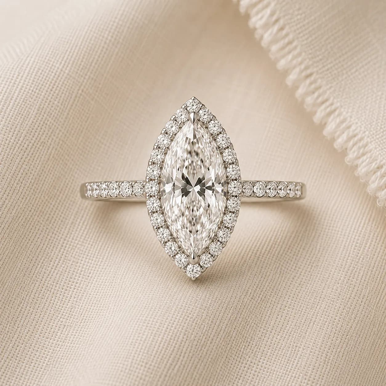 Marquise halo engagement ring with diamond halo and pavé band