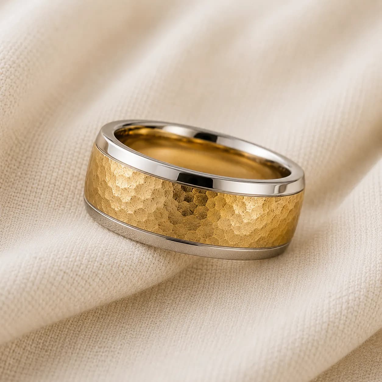 Unique men's wedding band with hammered finish and mixed metal on cream linen at ATL Luxury Jewelry Atlanta