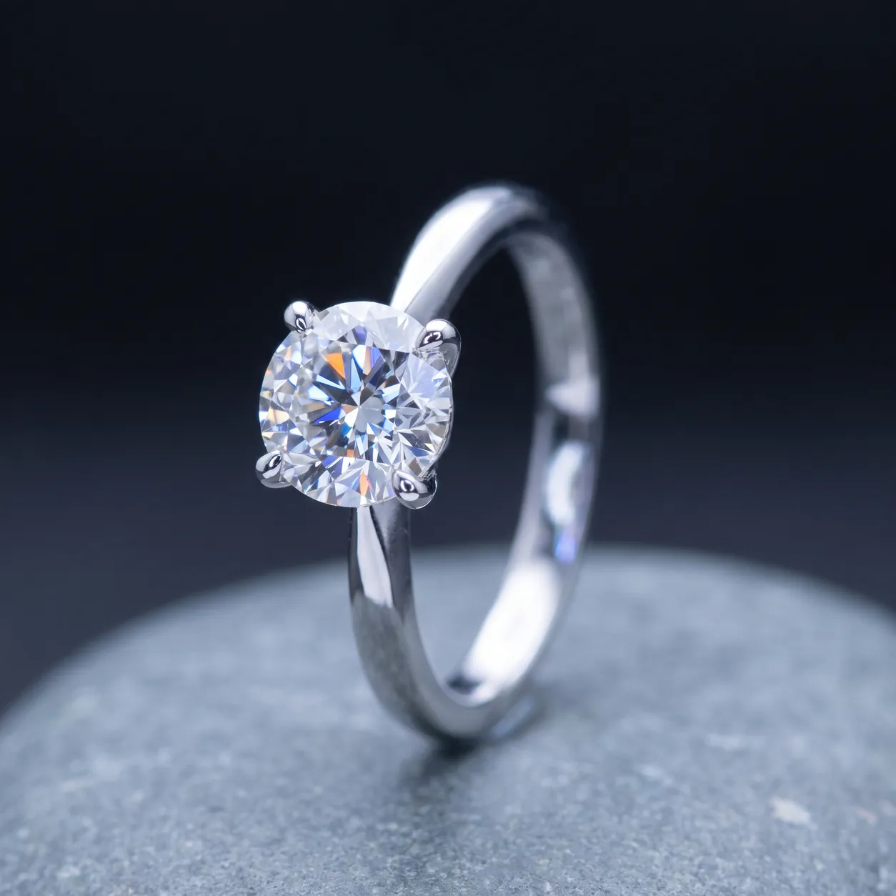 A white gold solitaire setting holding a near-colorless round brilliant diamond