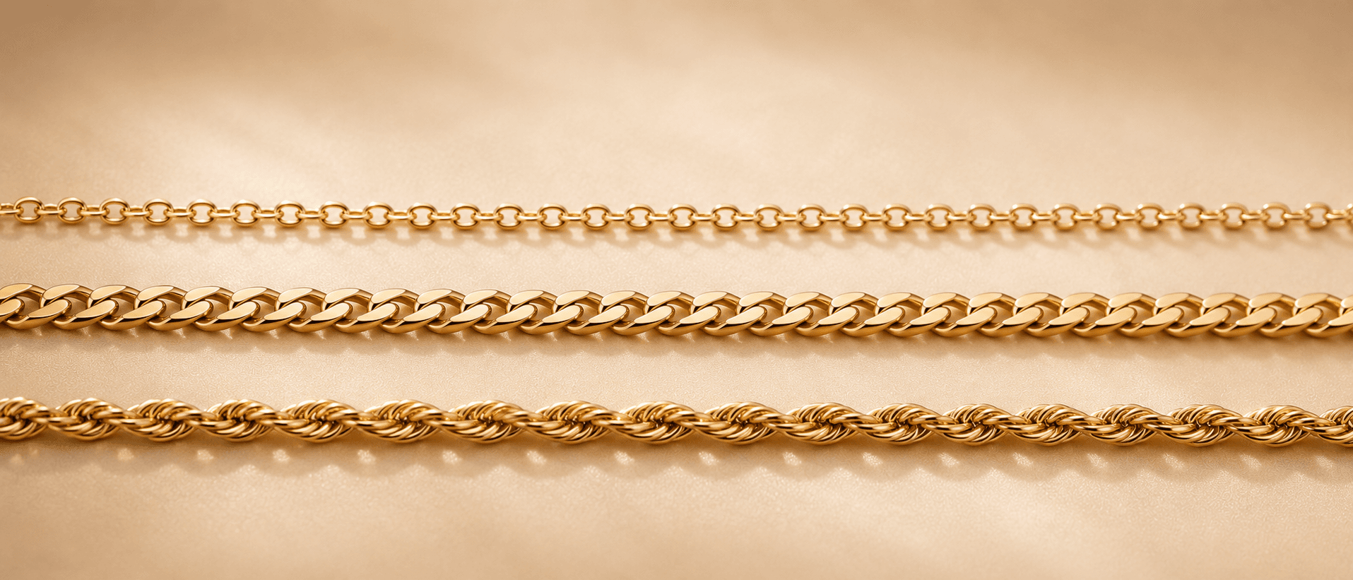 14K yellow gold Cuban link chain on cream linen at ATL Luxury Jewelers Atlanta