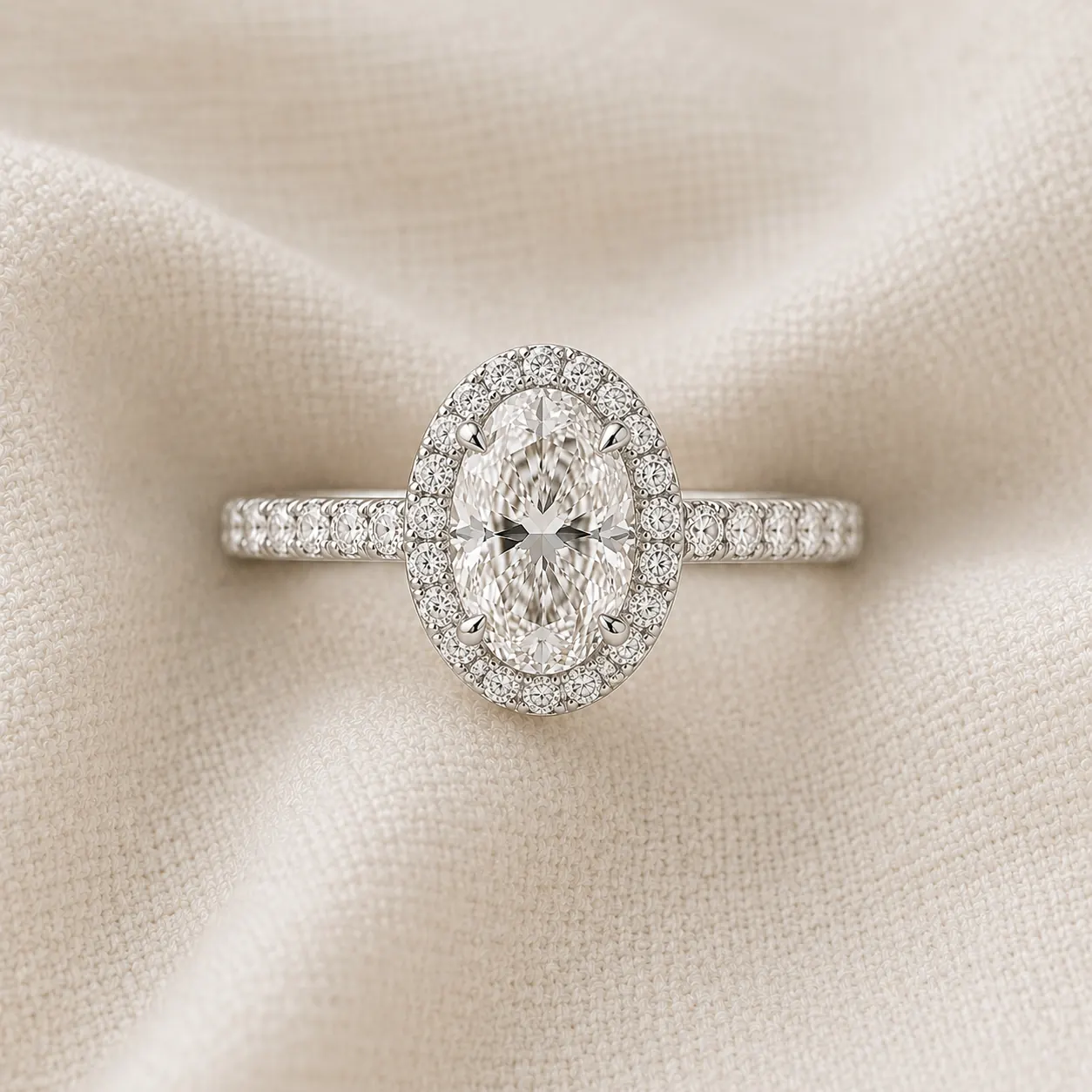 Oval cut halo engagement ring with pavé diamond halo surrounding the center stone
