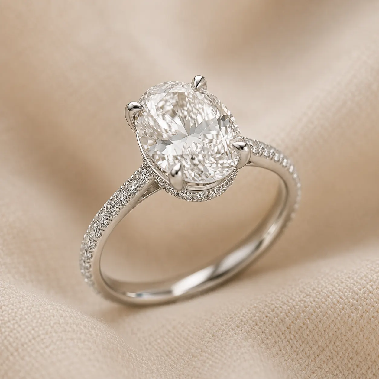 Oval cut engagement ring with hidden halo of diamonds beneath the center stone