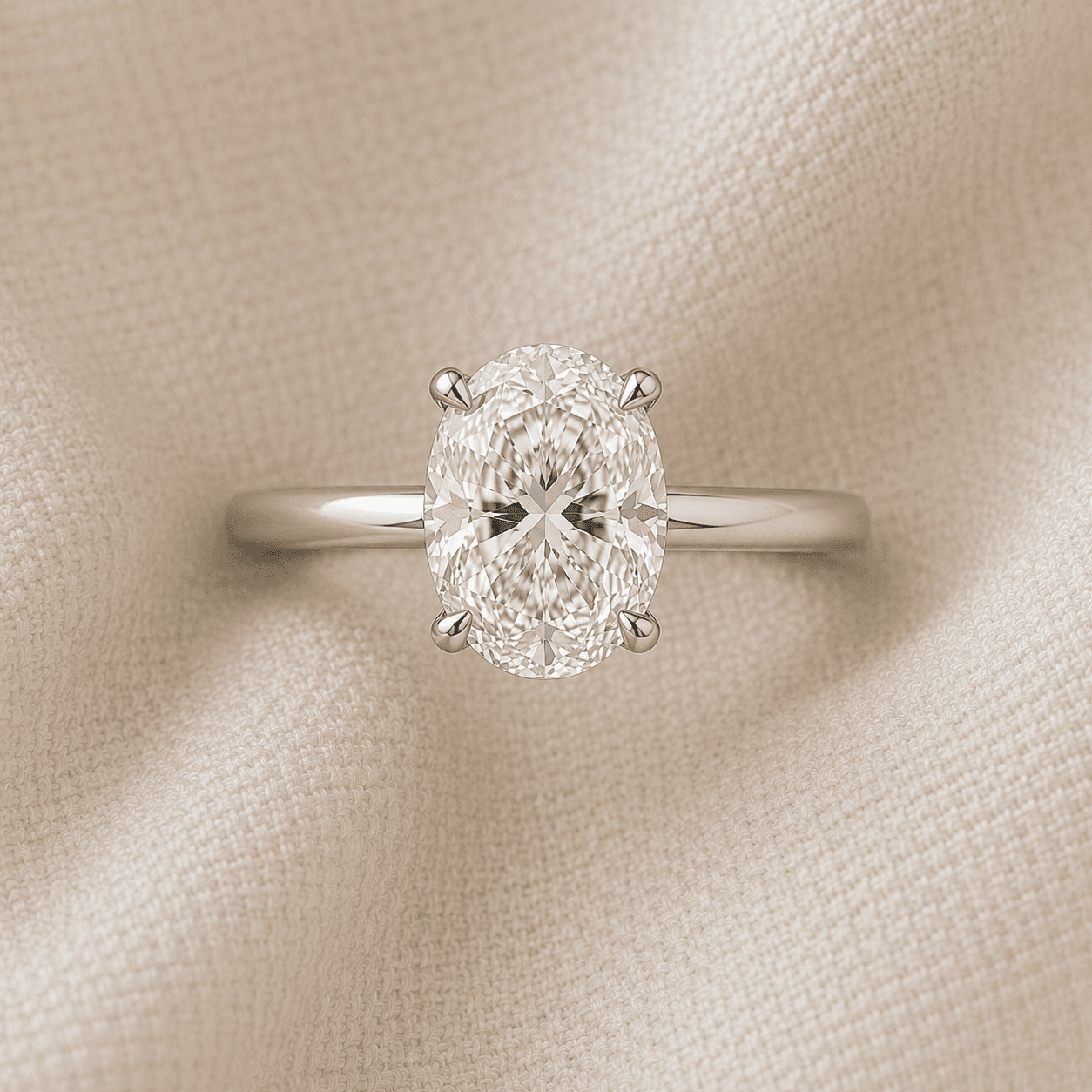 Oval cut solitaire engagement ring with four-prong setting in white gold