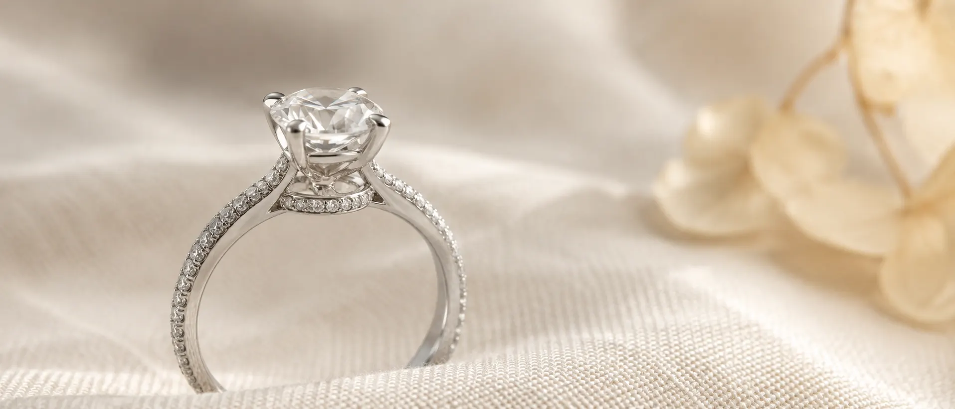 Pavé-band diamond engagement ring with hidden halo on cream linen at ATL Luxury Jewelry Atlanta