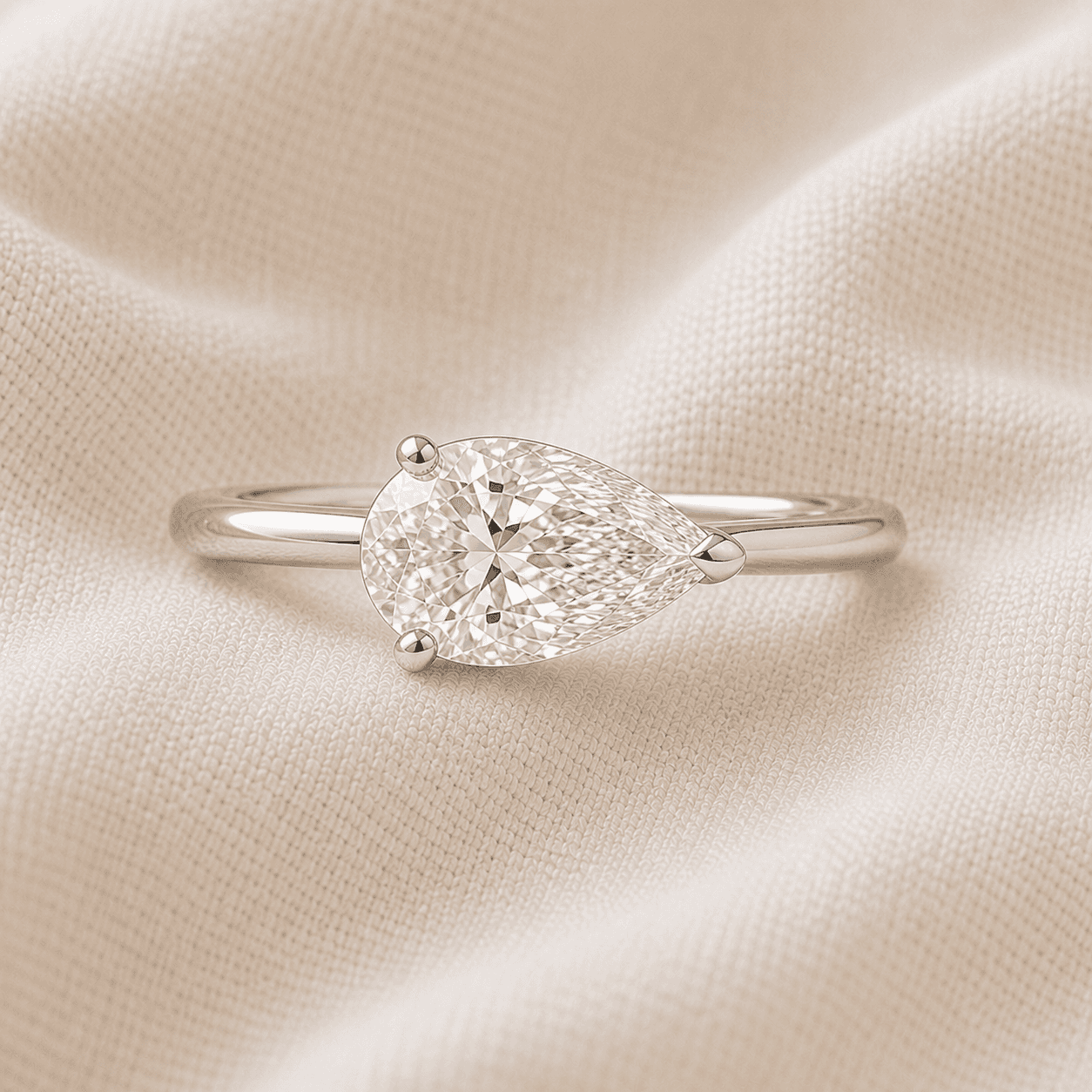 East-west pear cut engagement ring set horizontally