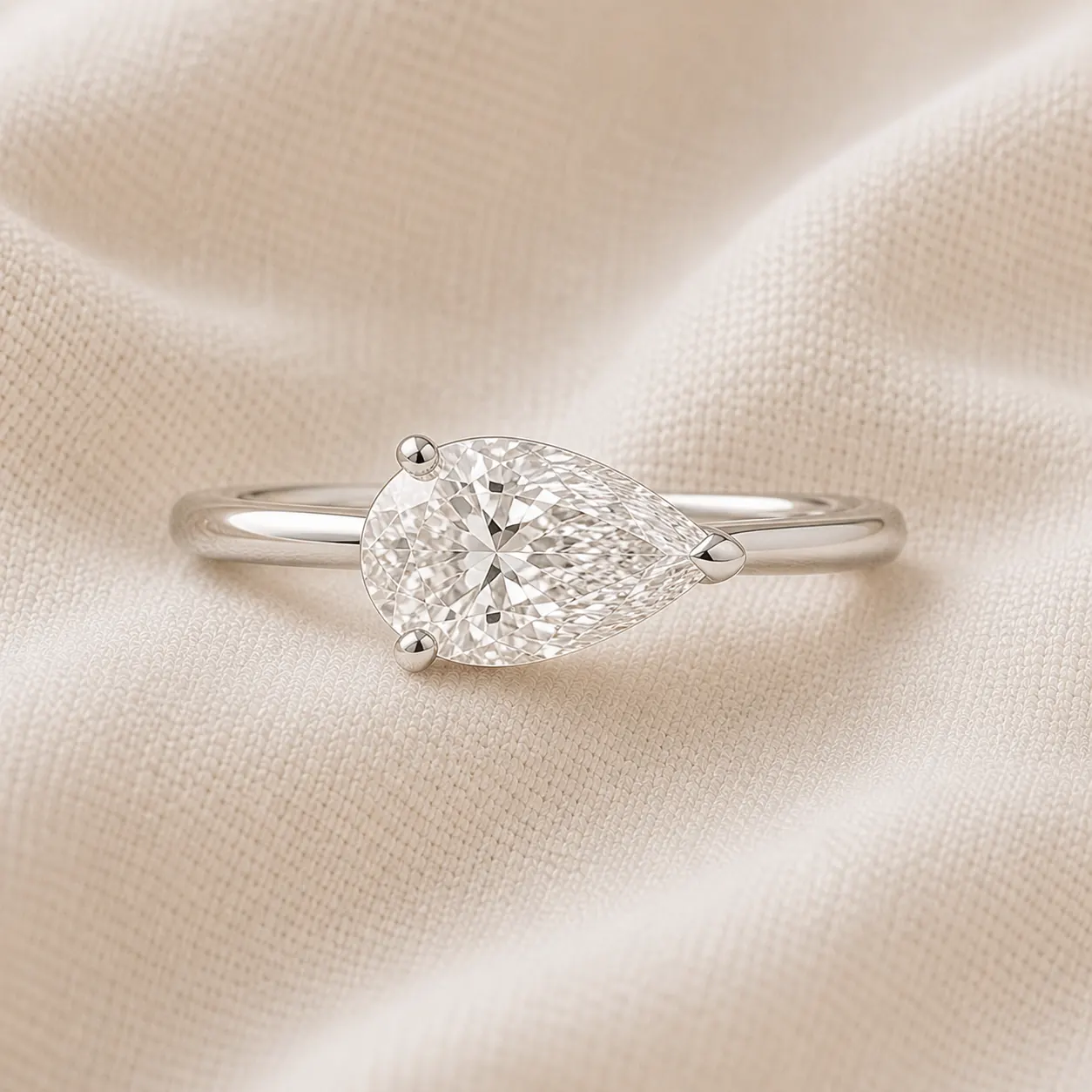 East-west pear cut engagement ring set horizontally