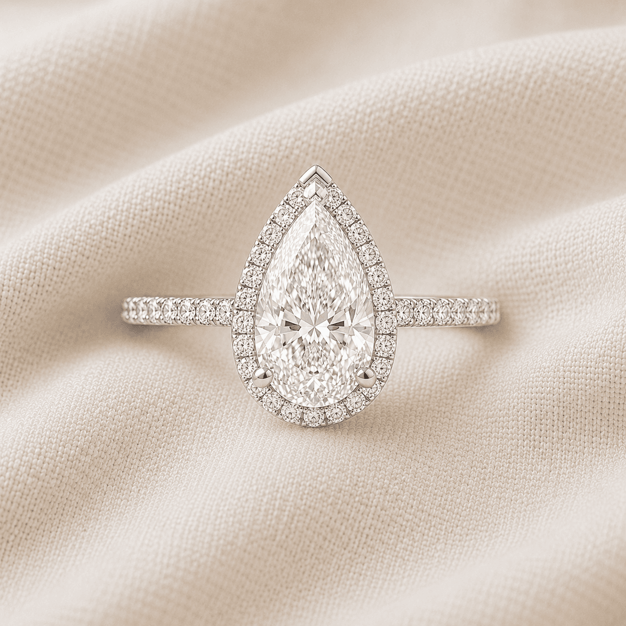Pear cut halo engagement ring with pavé diamond halo