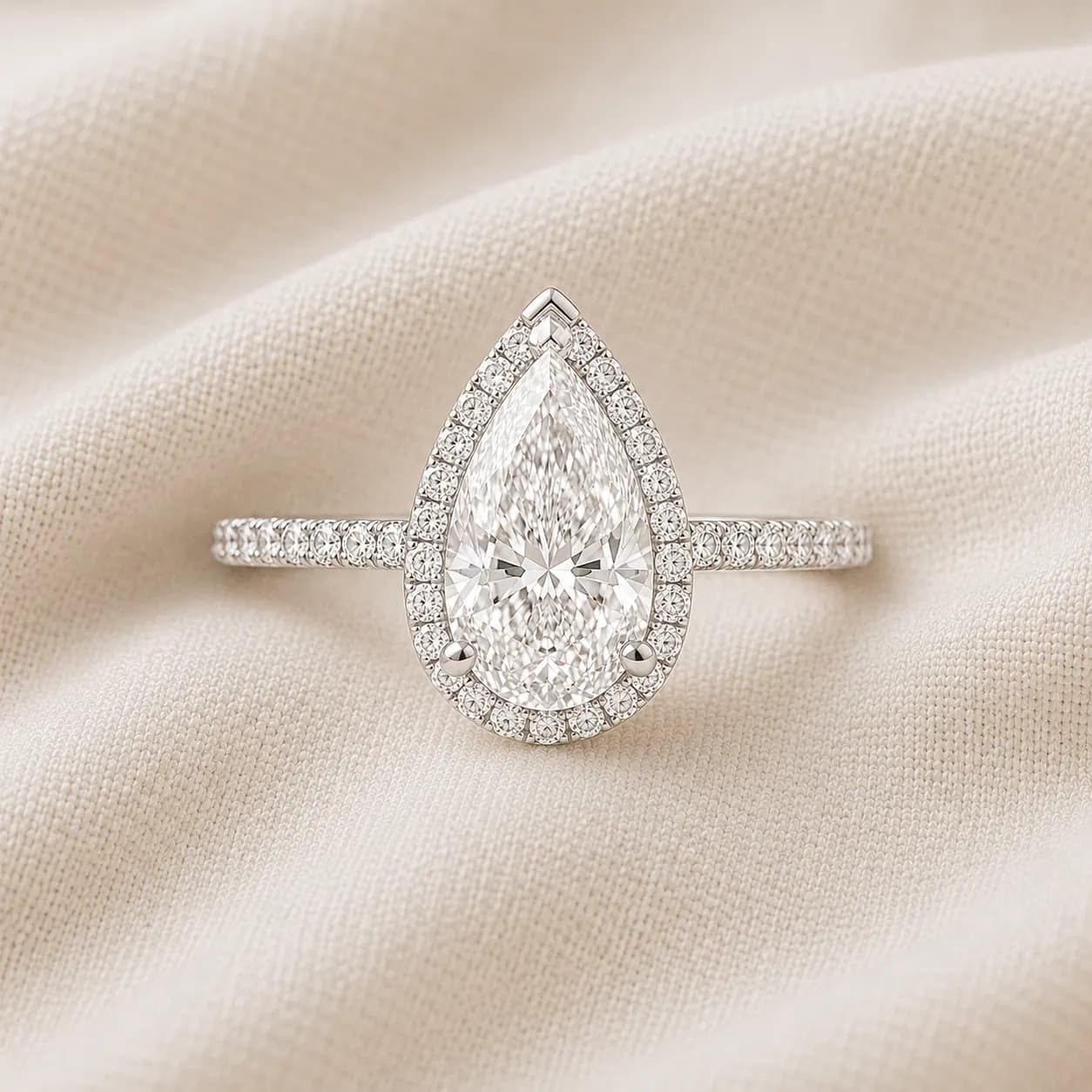Pear cut halo engagement ring with pavé diamond halo