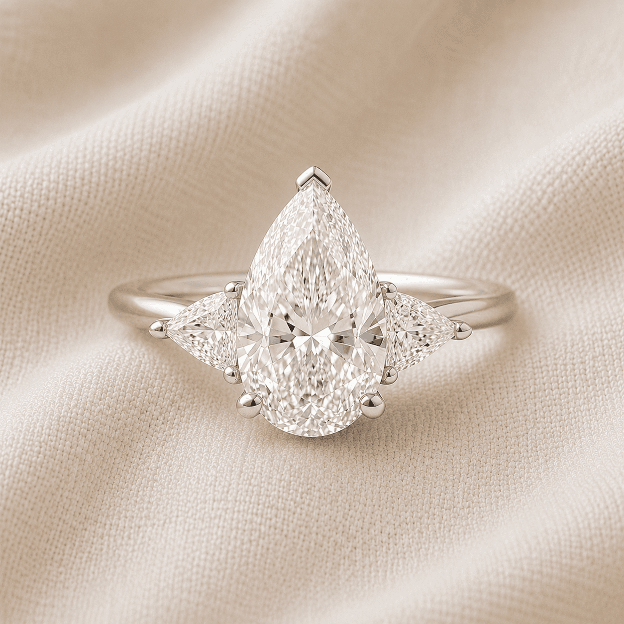 Pear cut three stone engagement ring
