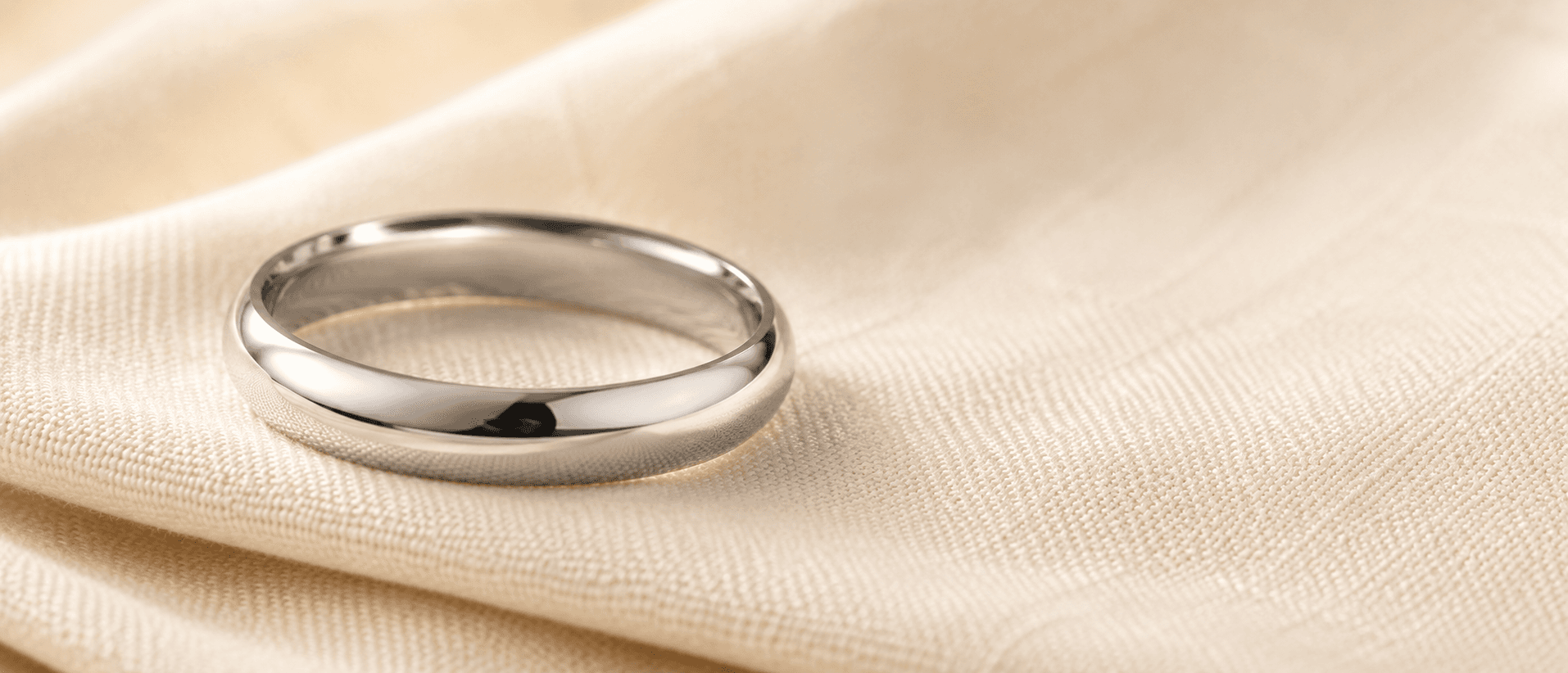Platinum wedding band on cream linen, handcrafted at ATL Luxury Jewelers in Atlanta