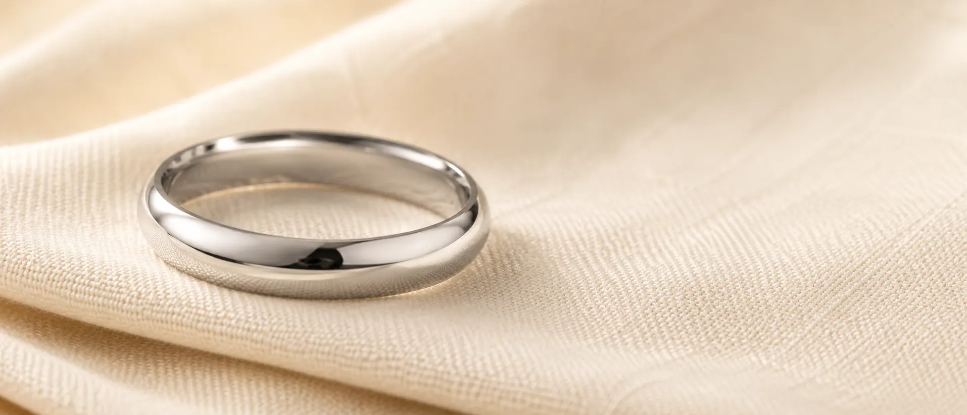 Platinum wedding band on cream linen, handcrafted at ATL Luxury Jewelry in Atlanta