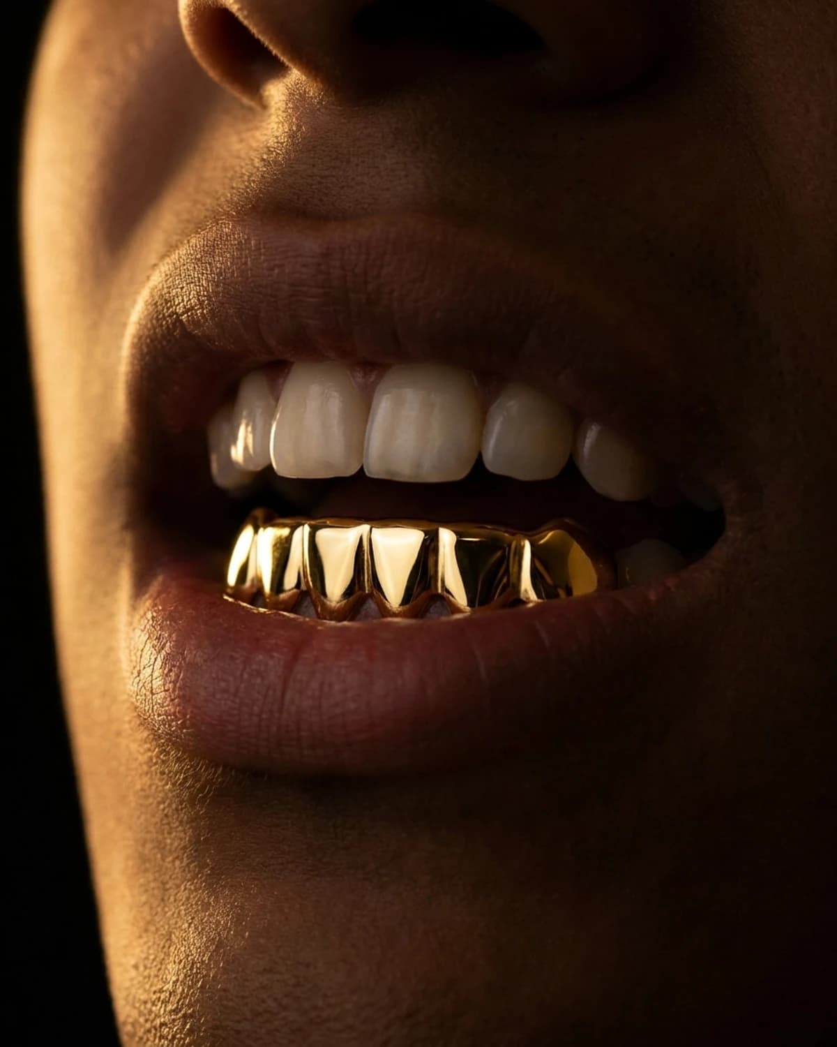 Design prototype — a rendering of a plain yellow gold grillz set worn over the lower teeth, a piece ATL Luxury Jewelry can make for you.