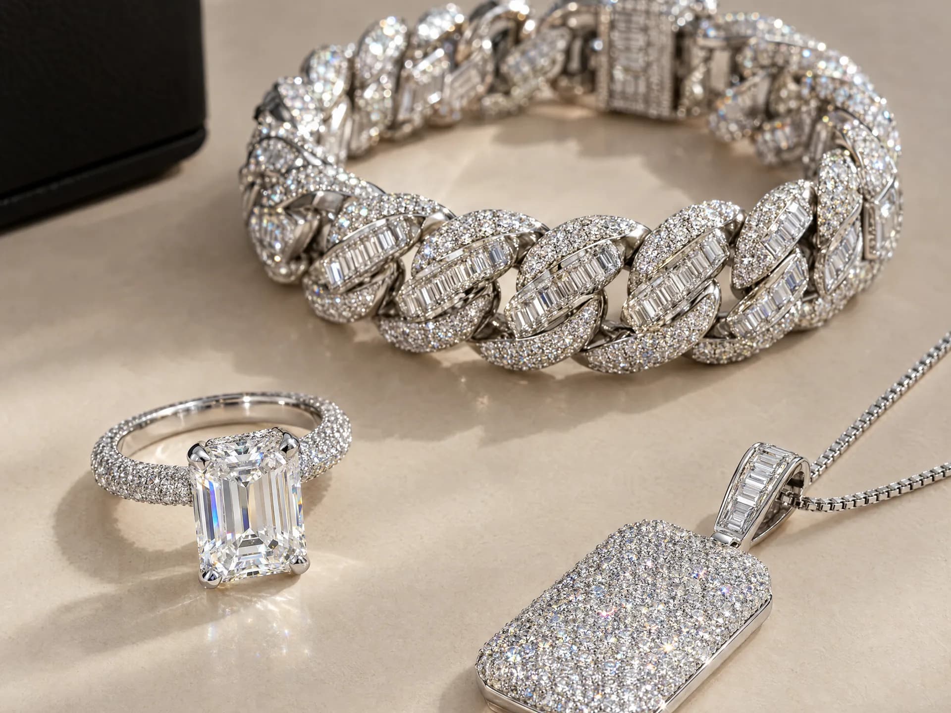Design prototype — a rendering of an iced white gold Cuban link bracelet, an emerald-cut engagement ring on a pavé band and a pavé tag pendant on a fine box chain ATL Luxury Jewelry can make for you