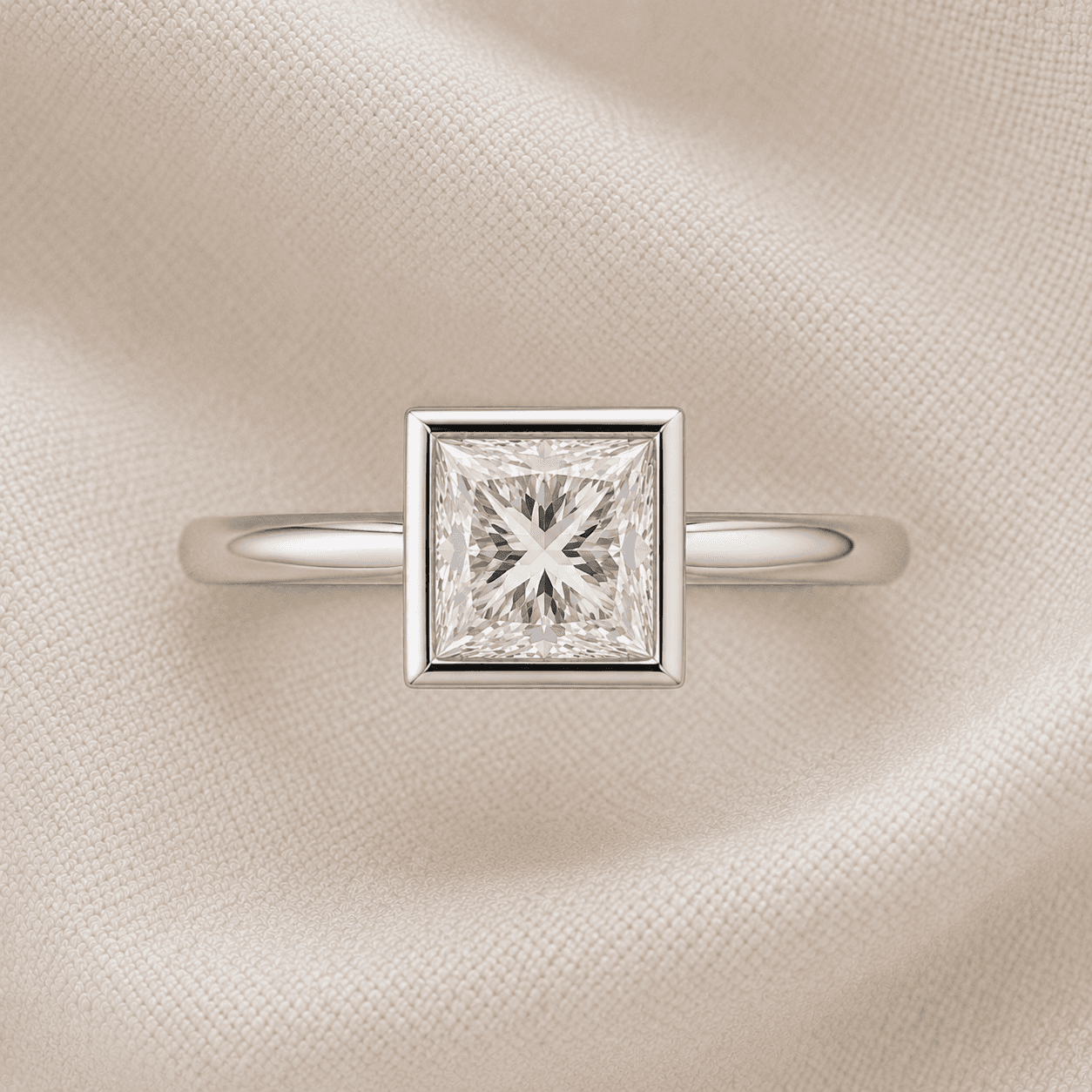 Bezel-set princess cut engagement ring with continuous platinum rim
