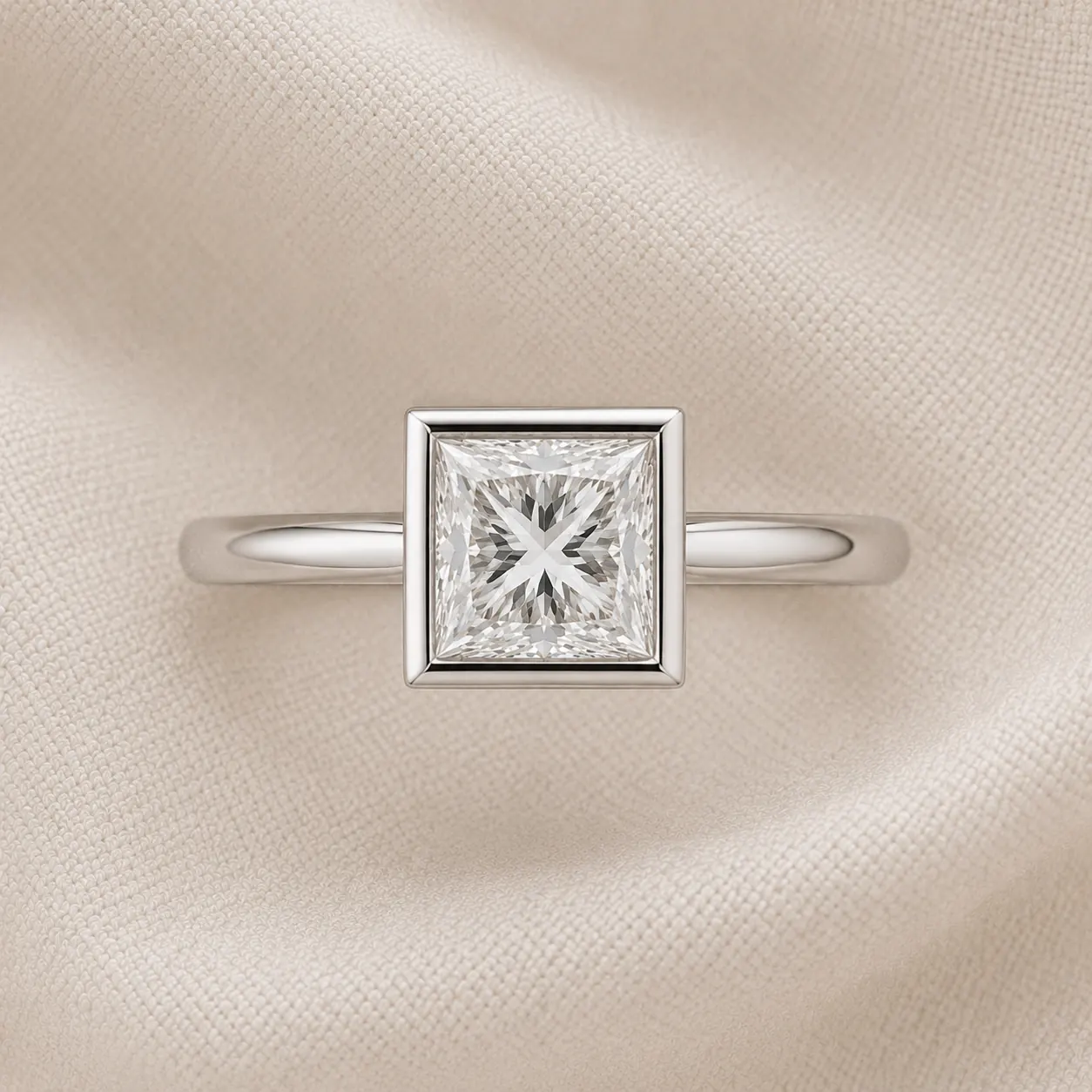Bezel-set princess cut engagement ring with continuous platinum rim