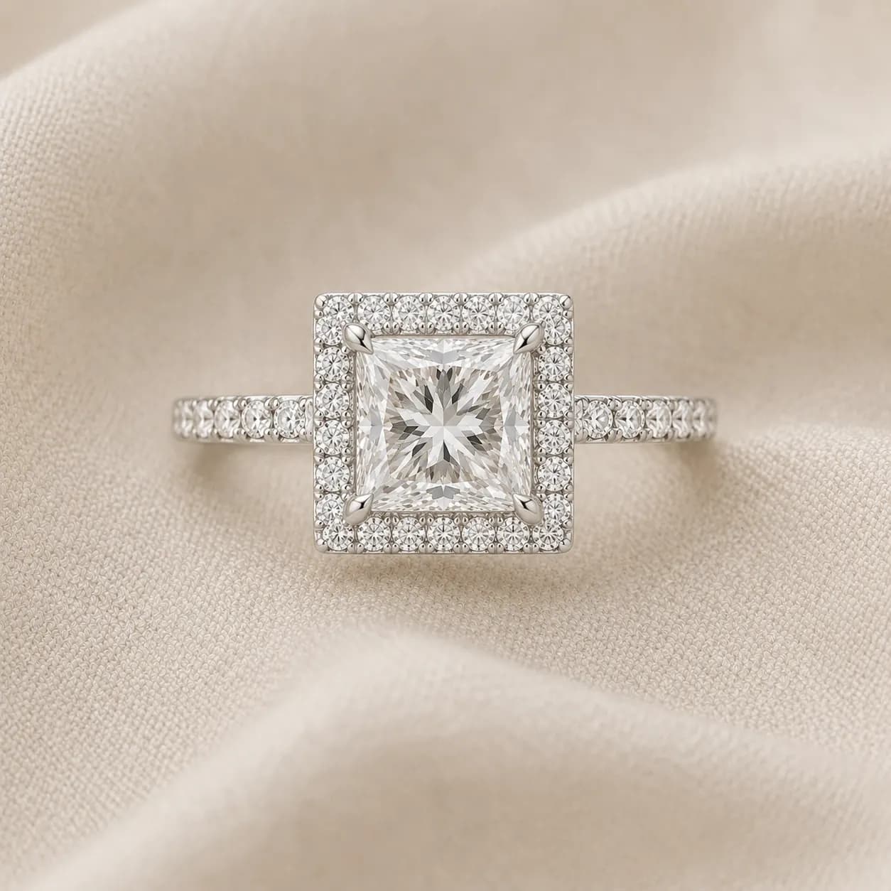 Princess cut halo engagement ring with pavé diamond halo surrounding the center stone