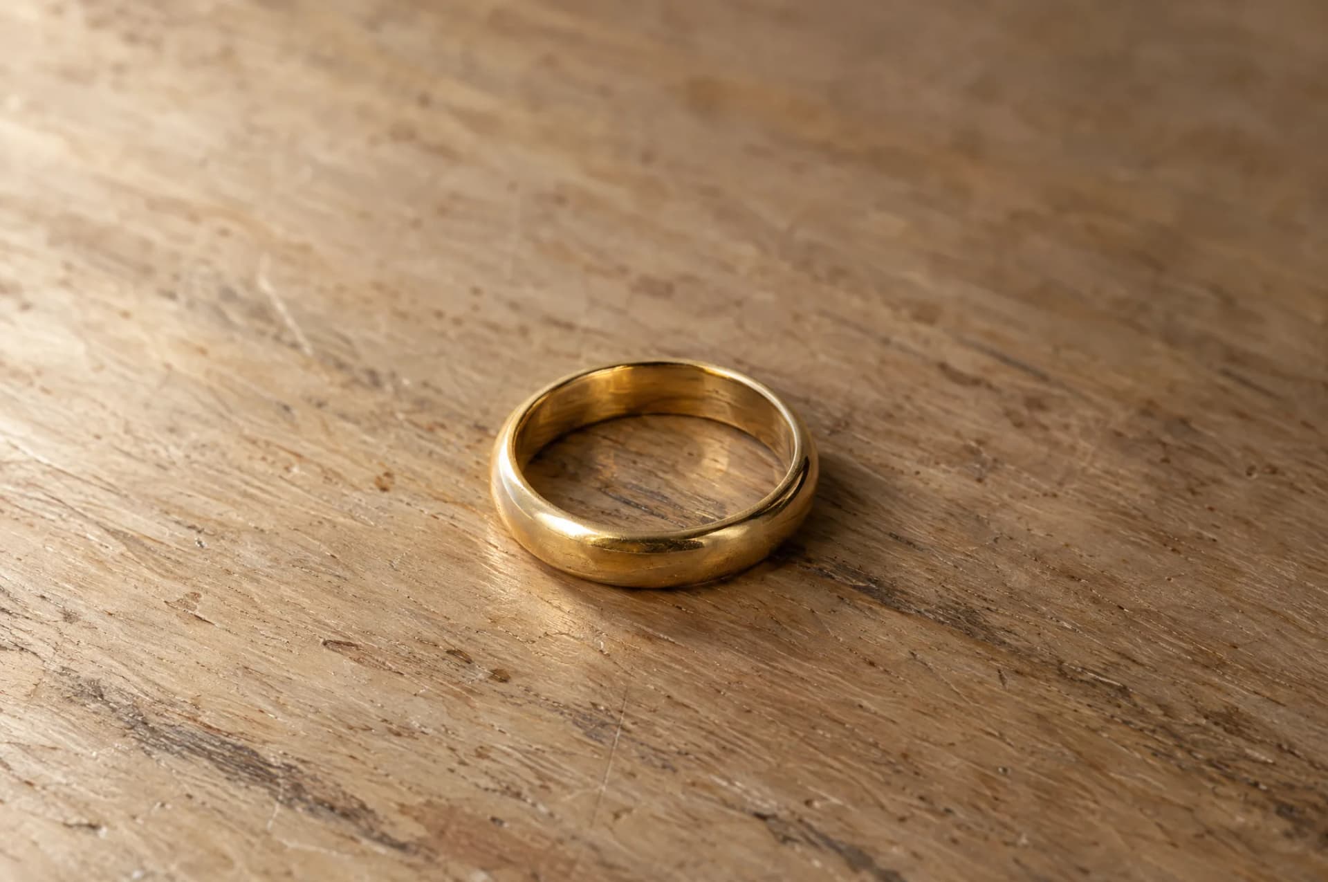 Rings resting on a plain wood surface, brought in for repair at ATL Luxury Jewelry, Snellville GA