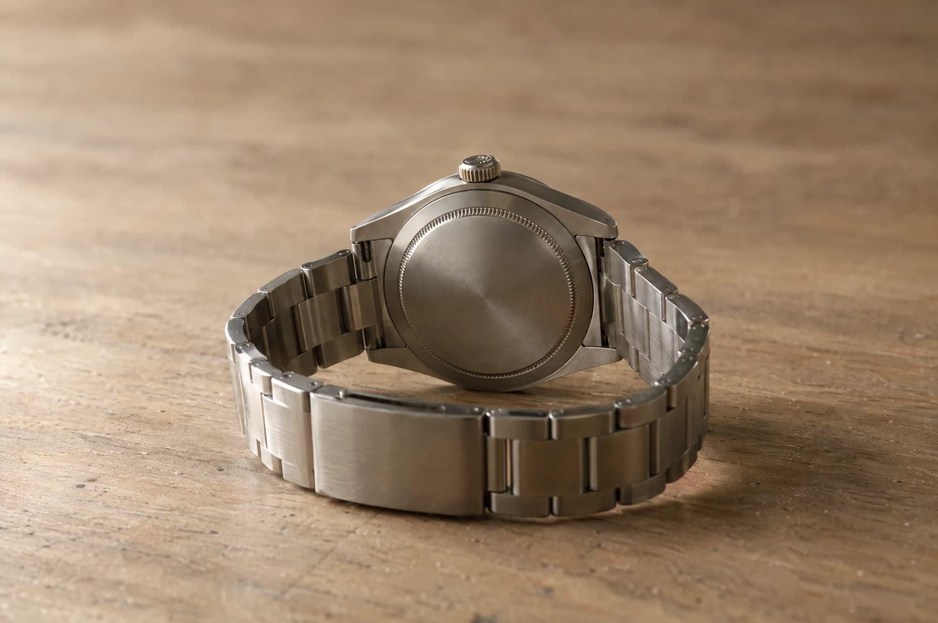Watches resting on a plain wood surface, brought in for repair at ATL Luxury Jewelry, Snellville GA