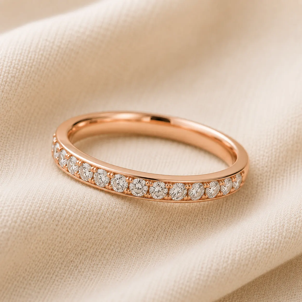 14K rose gold diamond half-eternity wedding band on cream linen at ATL Luxury Jewelry Atlanta