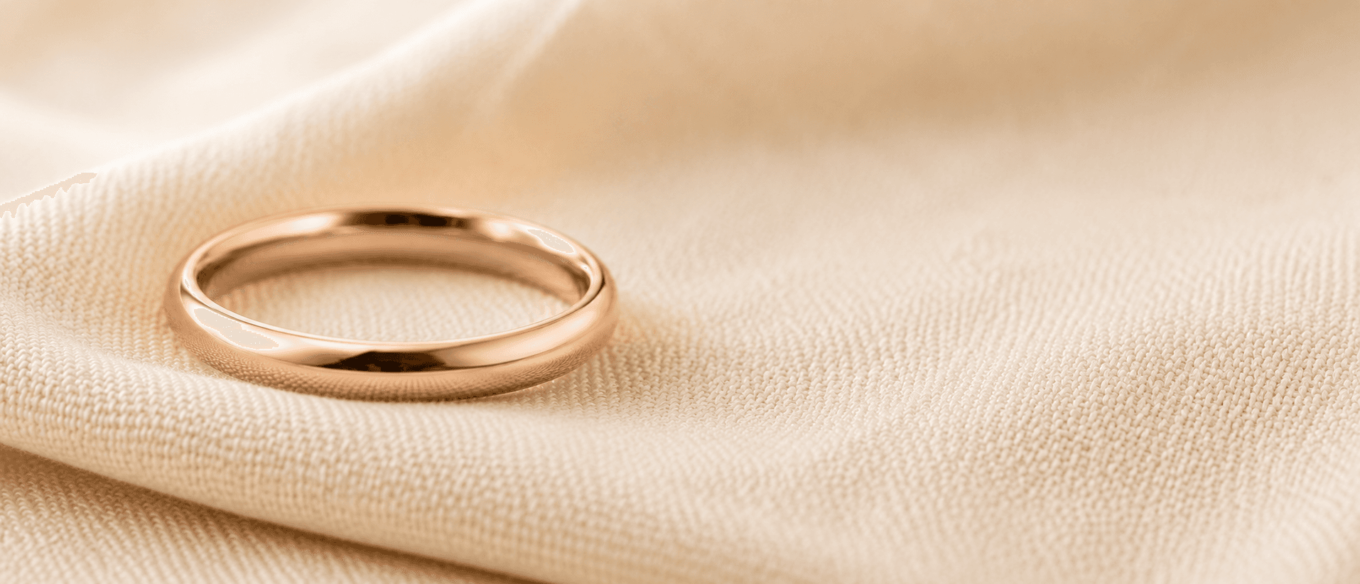 Rose gold wedding band on cream linen, handcrafted at ATL Luxury Jewelers in Atlanta