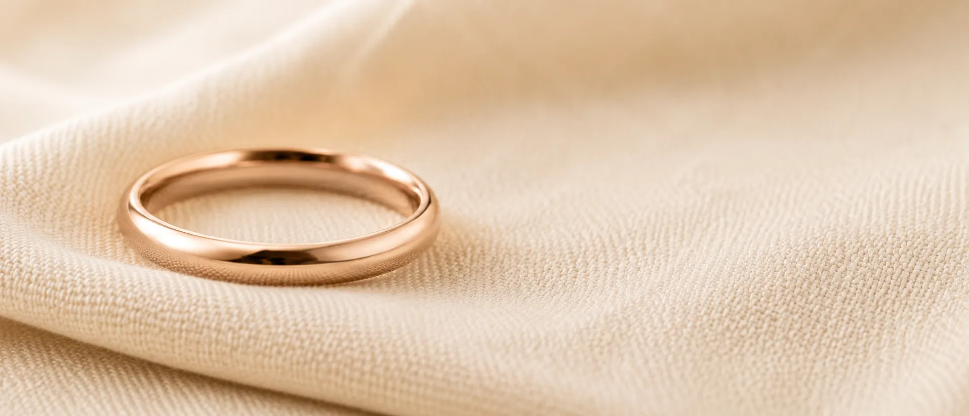Rose gold wedding band on cream linen, handcrafted at ATL Luxury Jewelry in Atlanta