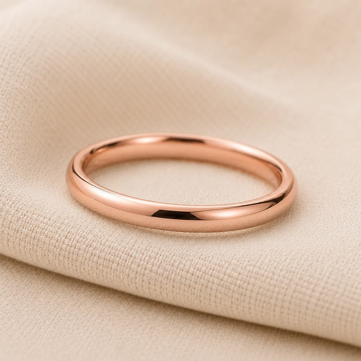 Slim 14K rose gold women's wedding band on cream linen at ATL Luxury Jewelry Atlanta